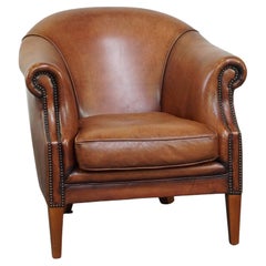 Comfortable leather club armchair with a loose seat cushion