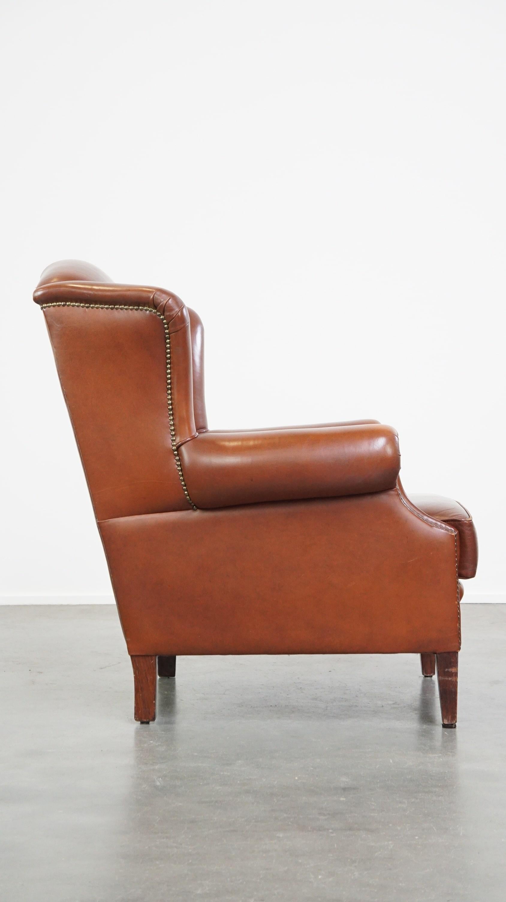 Hand-Crafted Comfortable, luxury English-style cognac-colored leather wingback armchair For Sale