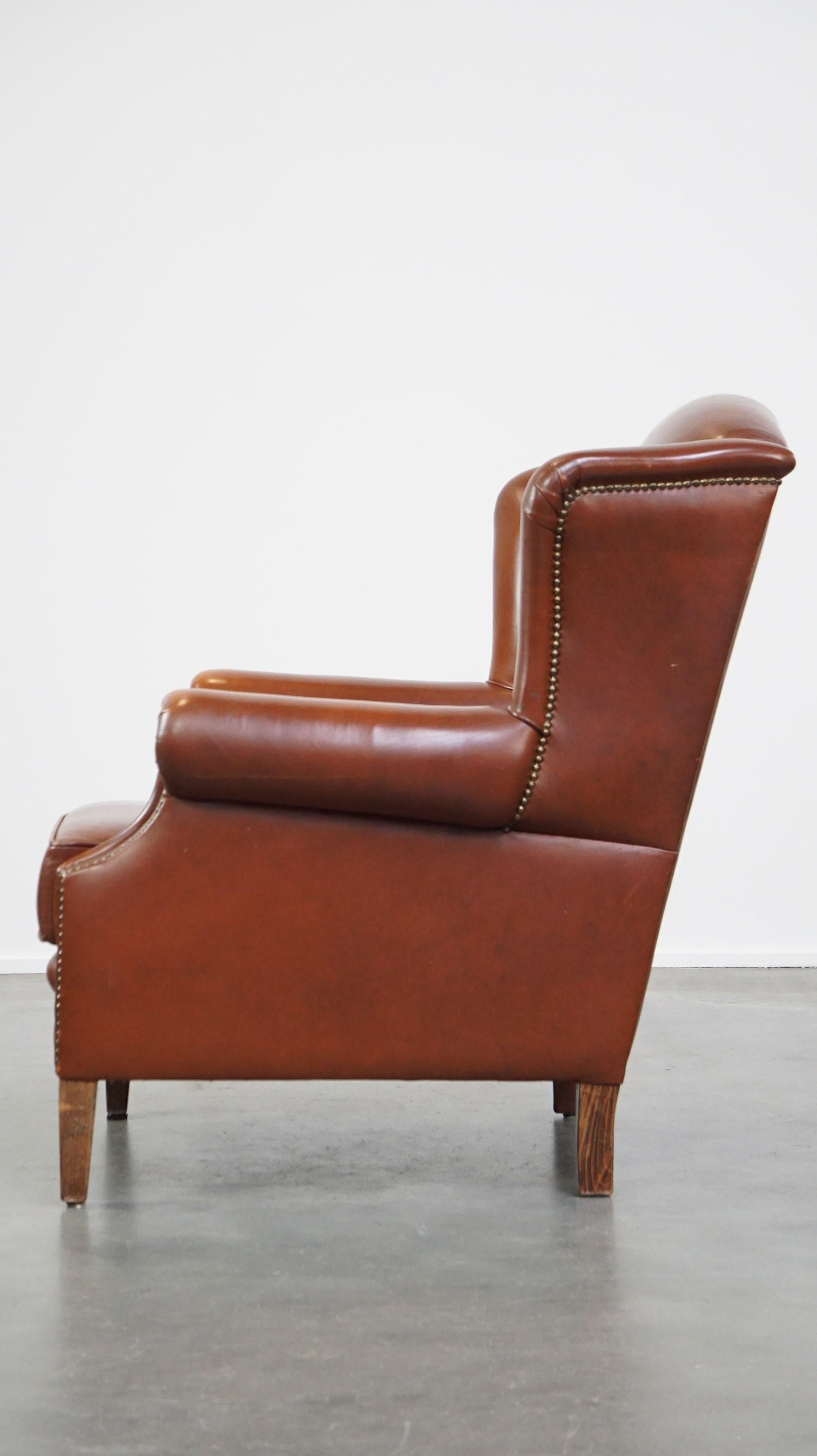 20th Century Comfortable, luxury English-style cognac-colored leather wingback armchair For Sale
