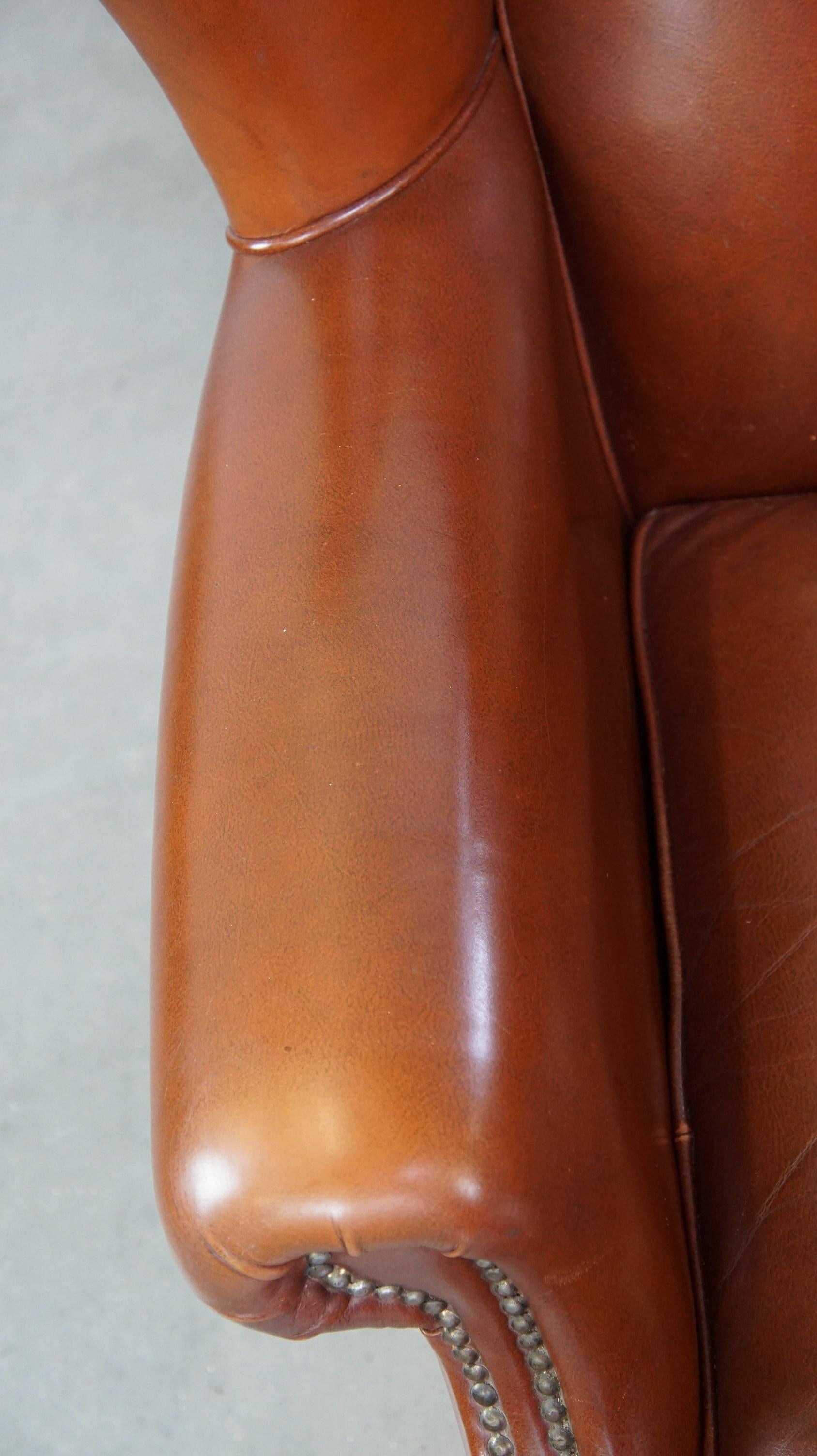 Comfortable, luxury English-style cognac-colored leather wingback armchair For Sale 1