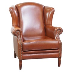 Used Comfortable, luxury English-style cognac-colored leather wingback armchair
