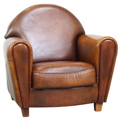 Confortable, finition soignée, grand fauteuil douillet en peau de mouton design.