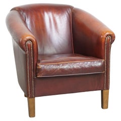 Comfortable, rugged cognac-colored sheepskin club armchair