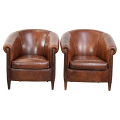 Comfortable set of two sheepskin club chairs with a vintage look