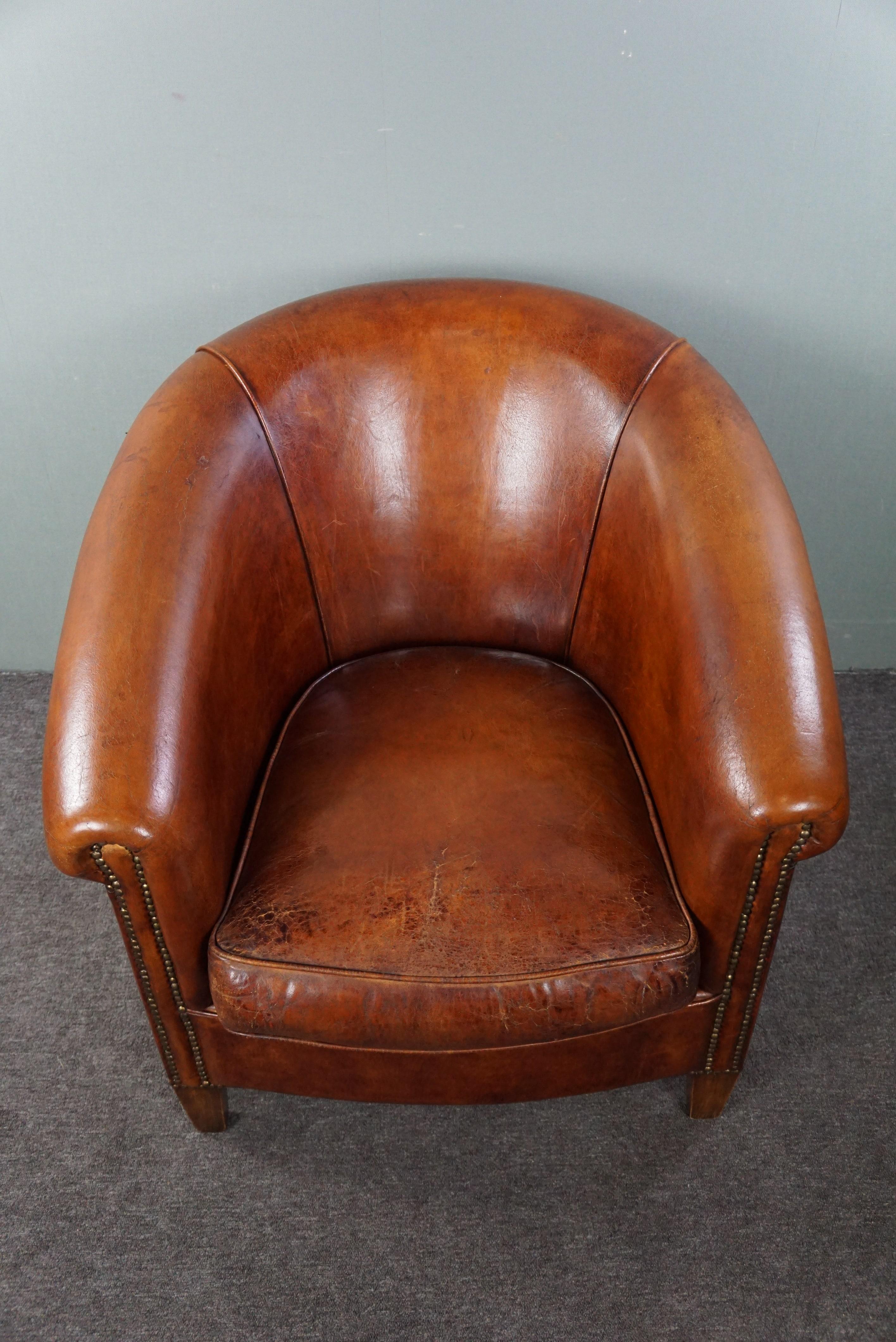 Leather Comfortable sheep leather club armchair in a warm cognac/chestnut color For Sale