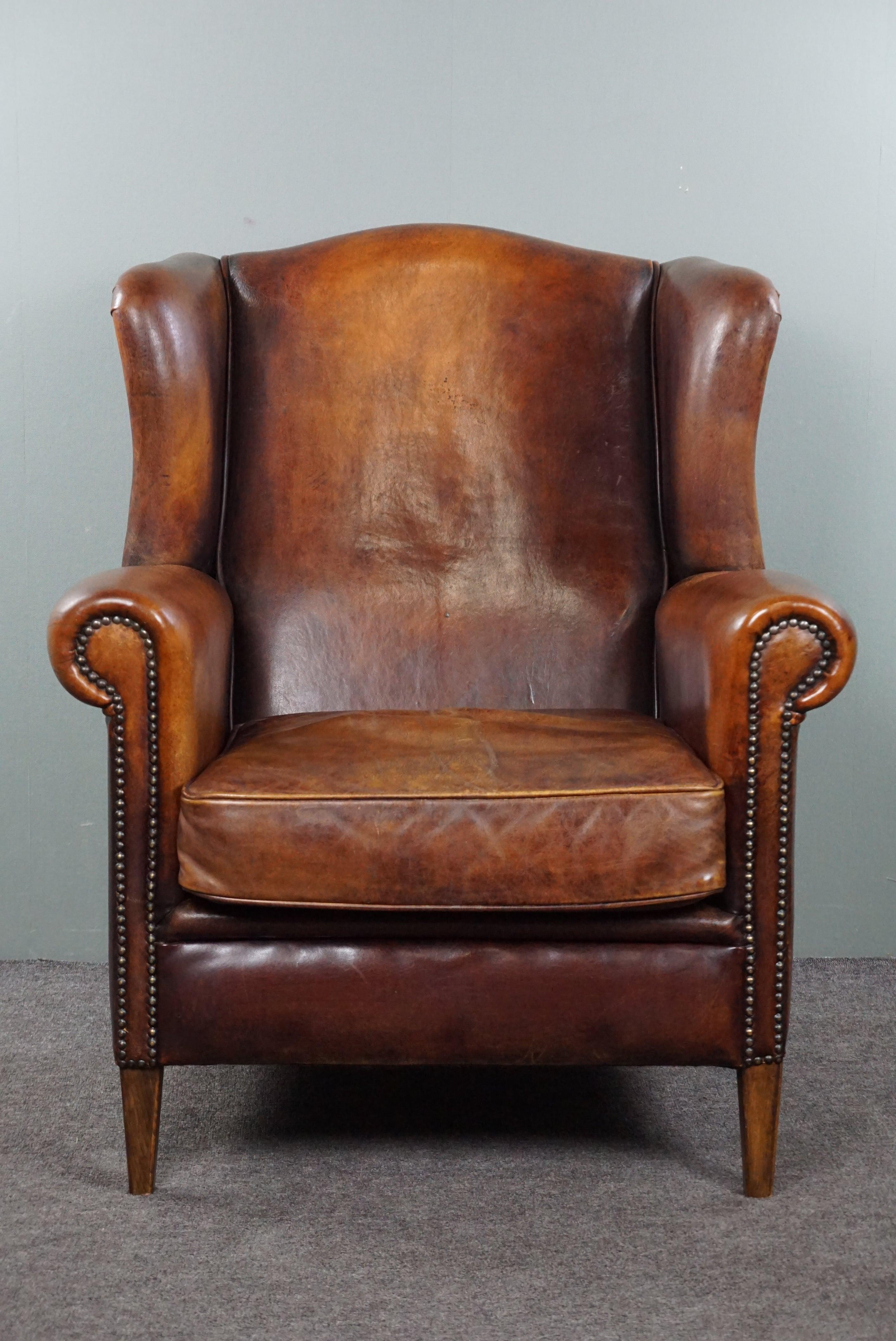 Offered is this beautiful and comfortable sheep leather wingback chair with fantastic warm hues. In this world, there will always be timeless classics. Whether it's a specific perfume, songs, or clothing items, almost everyone will know and