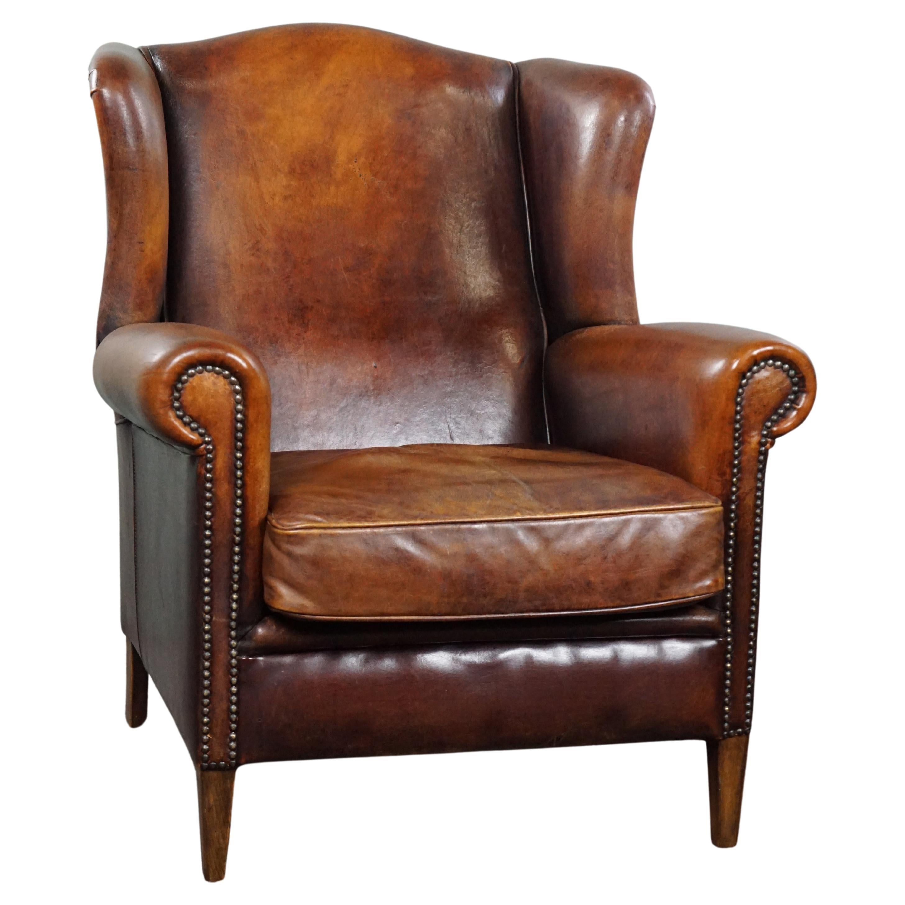 Comfortable sheep leather wingback chair with unbelievably warm colors For Sale
