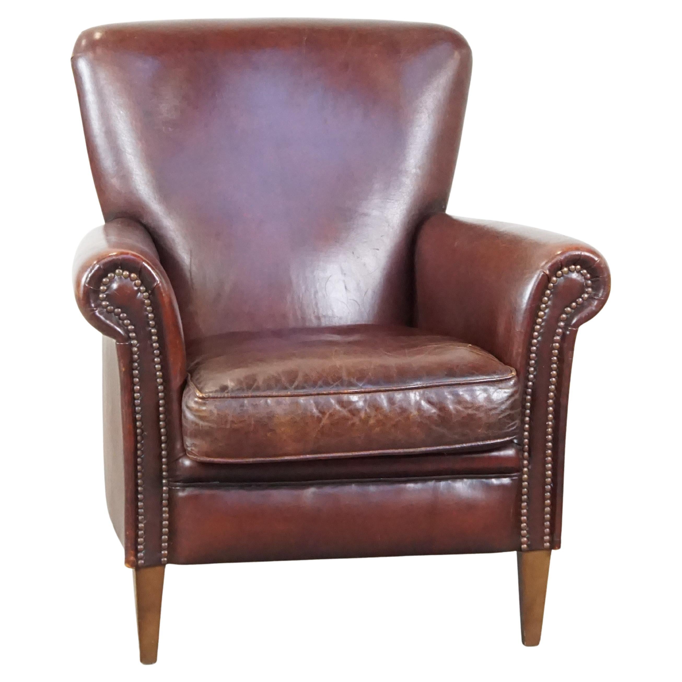 Comfortable sheepskin armchair with a proper finish and decorative nails