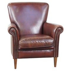 Comfortable sheepskin armchair with a proper finish and decorative nails