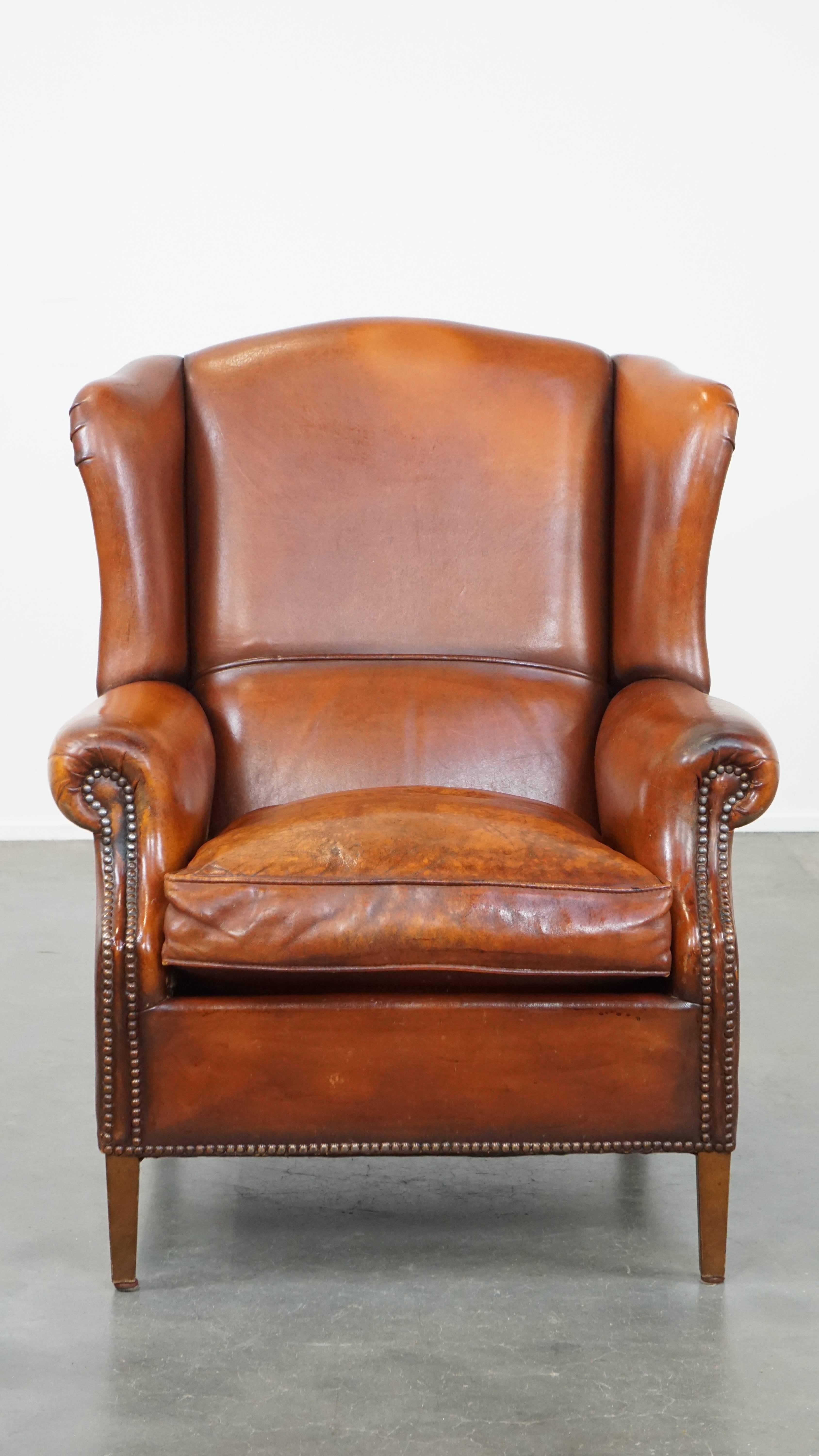 This fantastic sheepskin leather wingback chair is easy to incorporate into nearly any interior. It provides the perfect spot to relax in after a long day. The chair has a beautiful warm color scheme and is finished with decorative nails. It is
