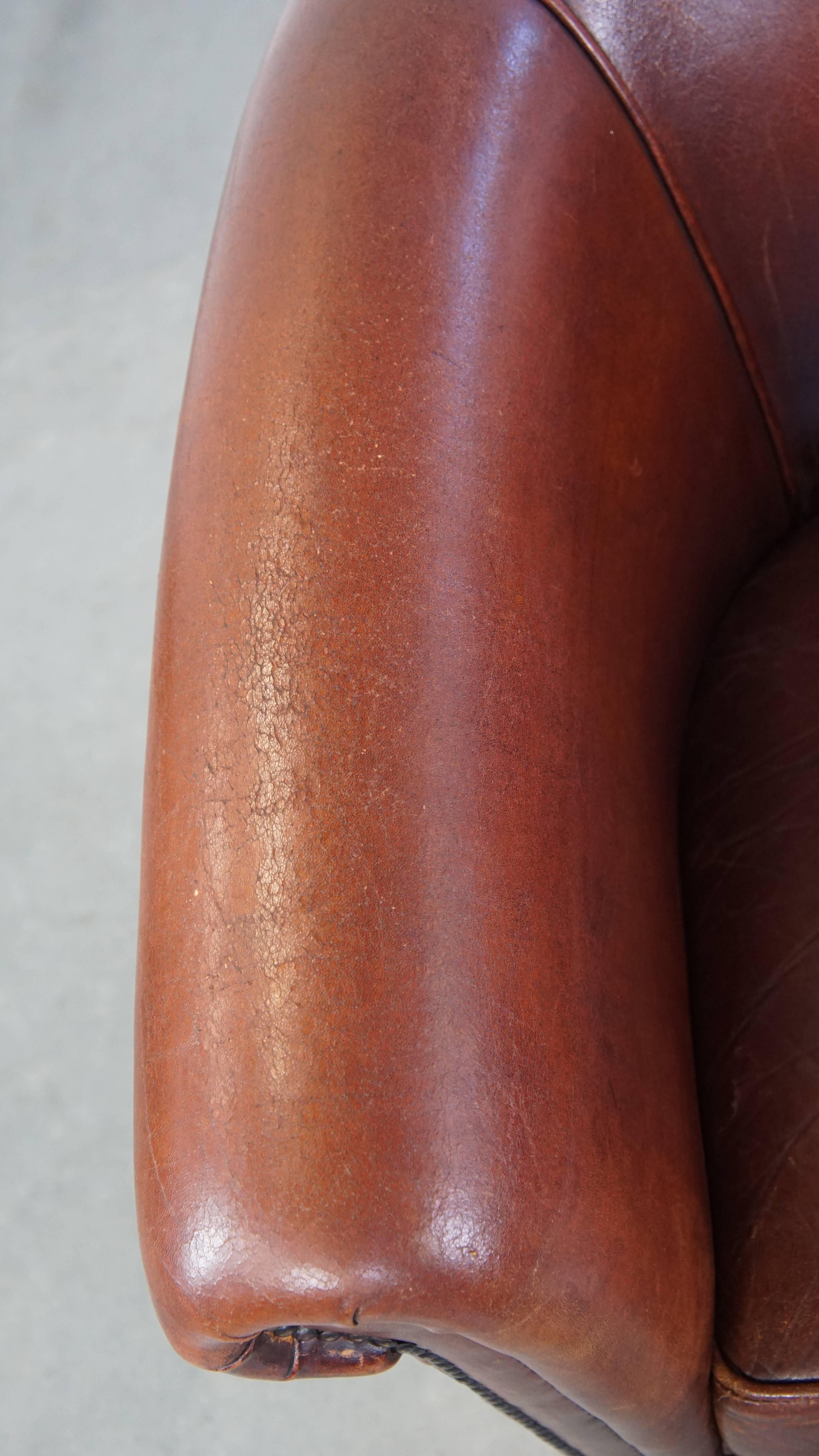 Leather Comfortable vintage English style sheepskin club chair with a beautiful patina For Sale