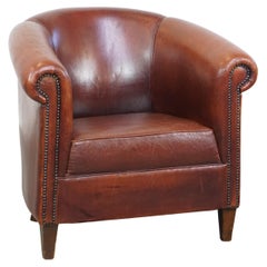 Comfortable vintage English style sheepskin club chair with a beautiful patina
