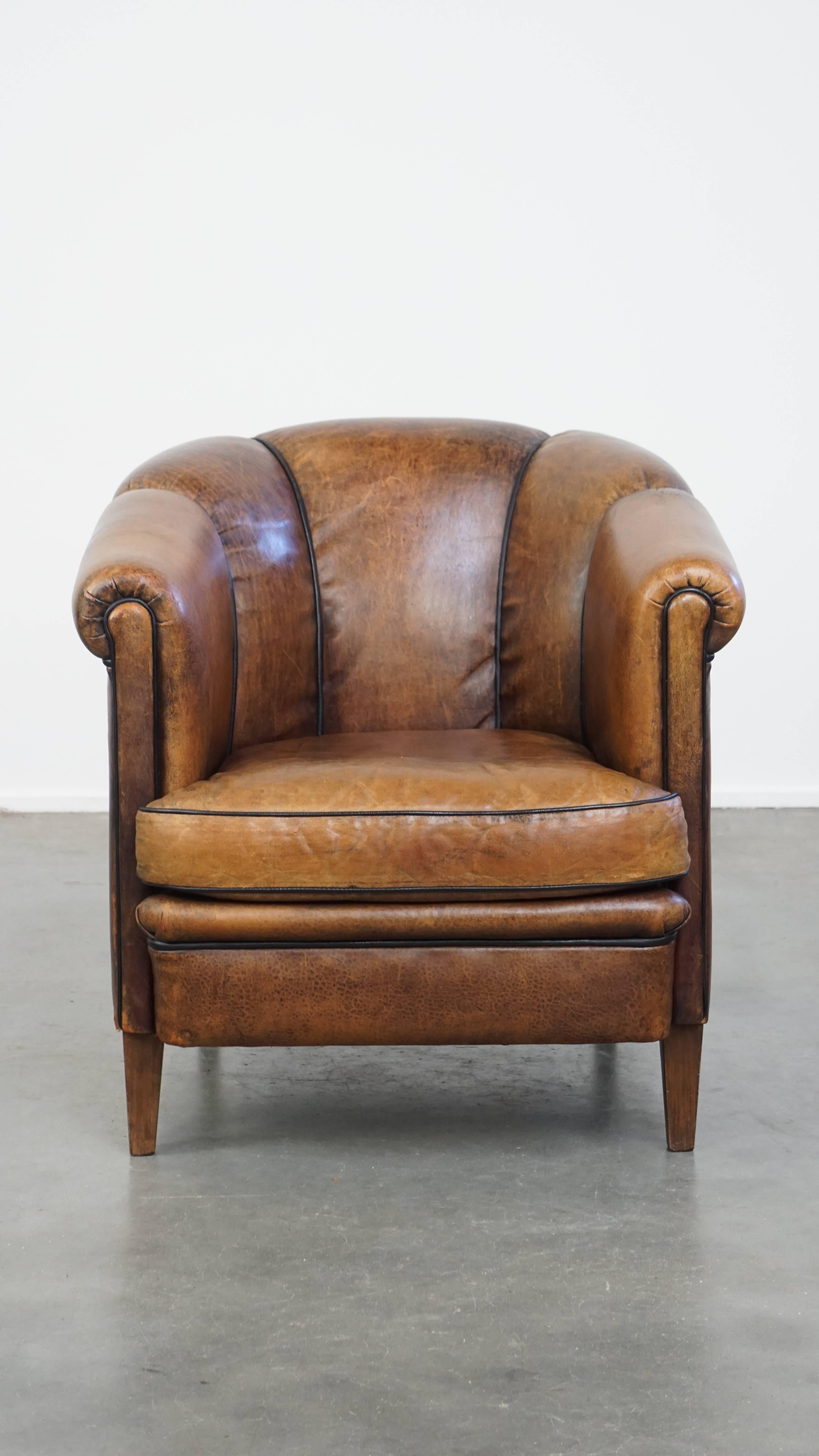 This irresistible vintage club chair is a true eye-catcher. Made from cognac-colored sheepskin leather, it is full of character. The chair is finished with black trim and features a uniquely designed backrest.

Equipped with a removable seat