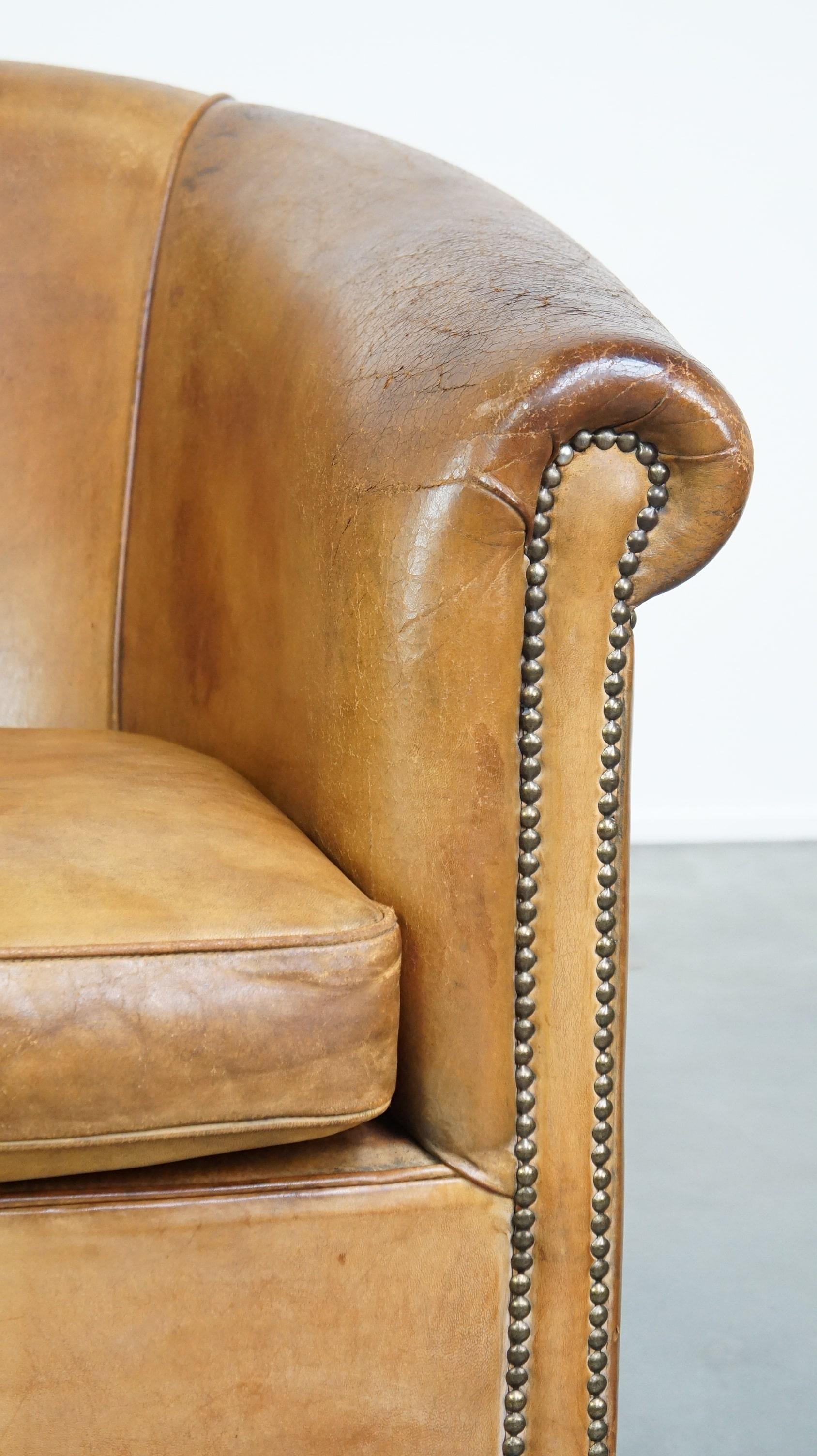Comfortable, warm colored sheepskin club chair finished with decorative nails For Sale 3