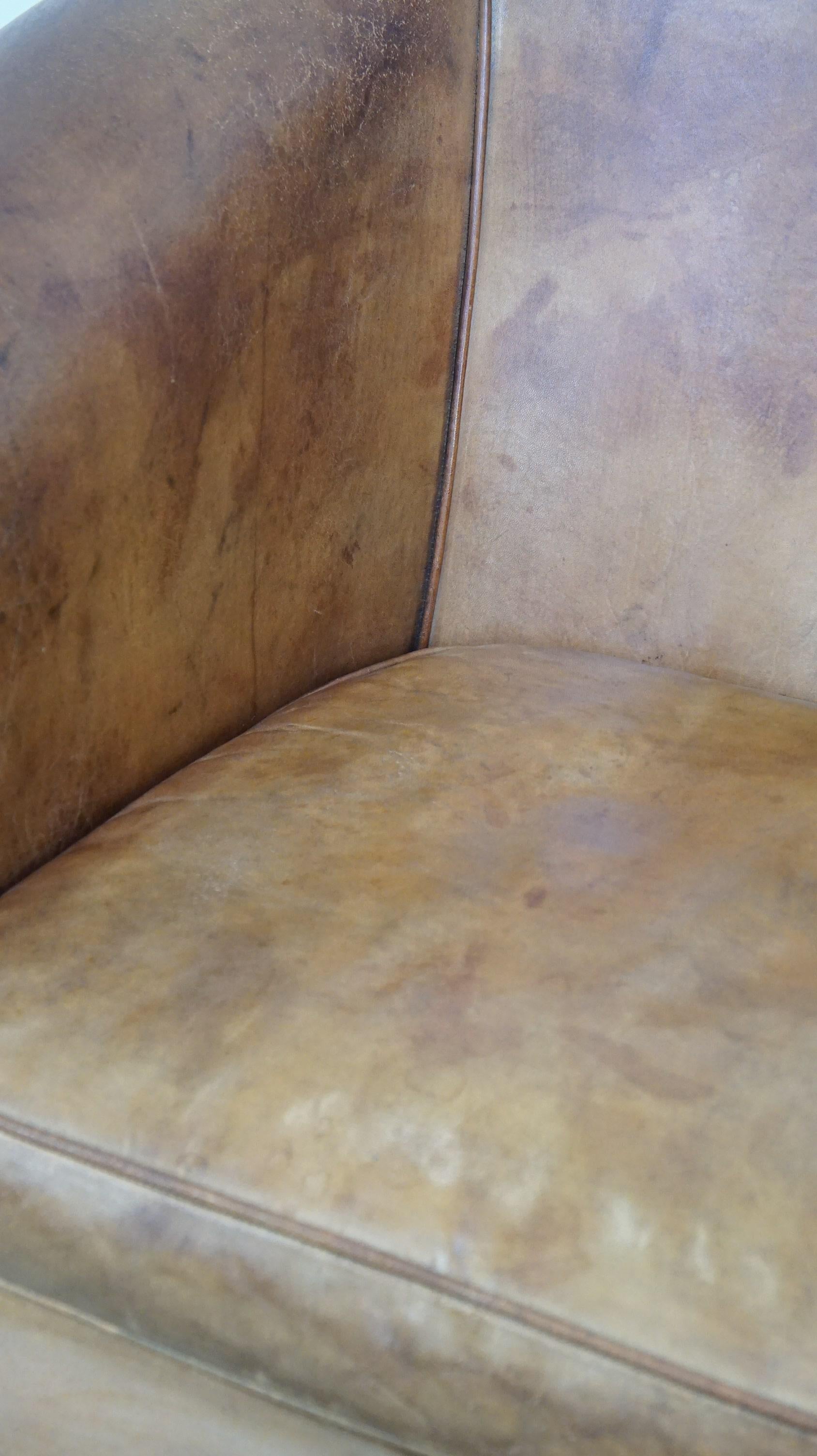 Comfortable, warm colored sheepskin club chair finished with decorative nails For Sale 4
