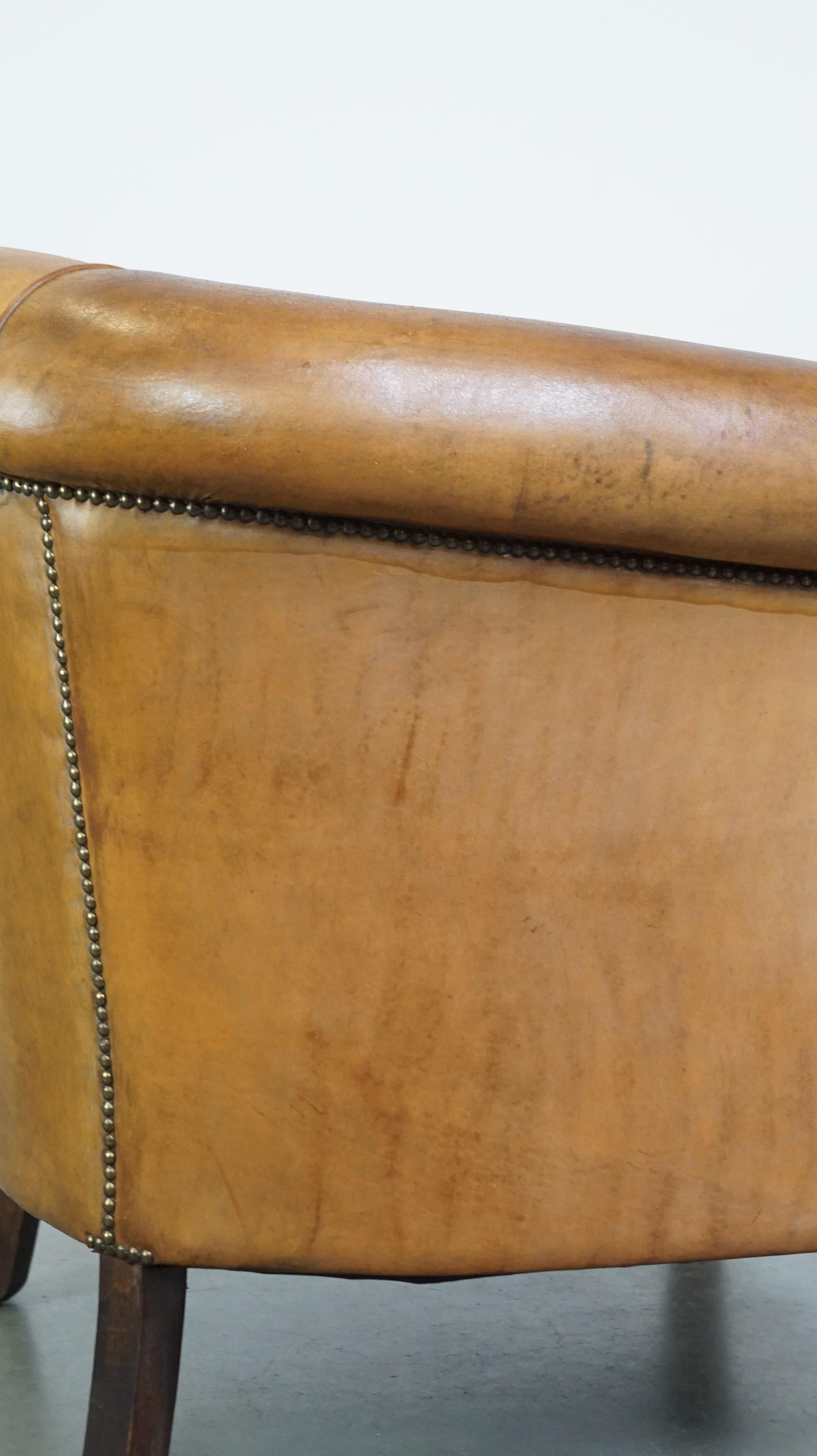 Comfortable, warm colored sheepskin club chair finished with decorative nails For Sale 5