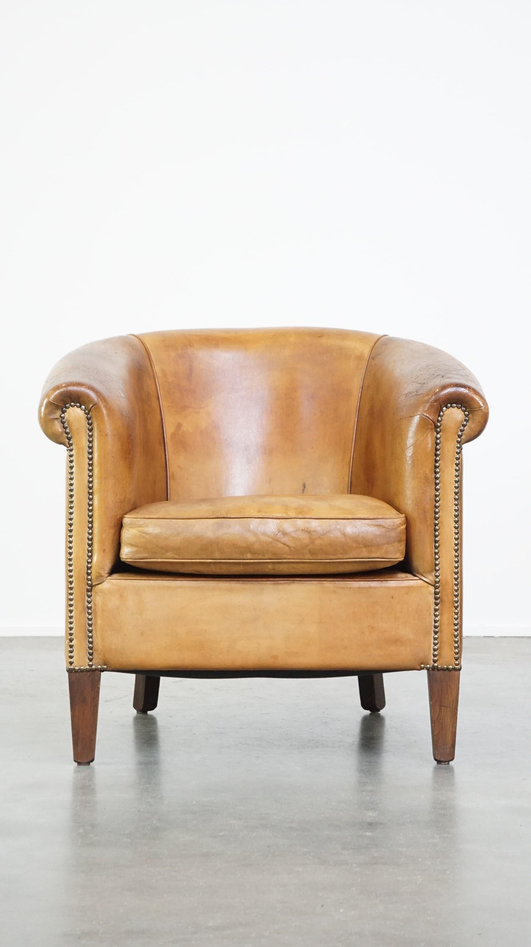 Offered this comfortable, cozy, warm colored sheep leather club chair finished with decorative nails.

If it were up to us, such a nice, cozy club chair should not be missing in any interior. It is made of sheep leather and, partly due to its color,