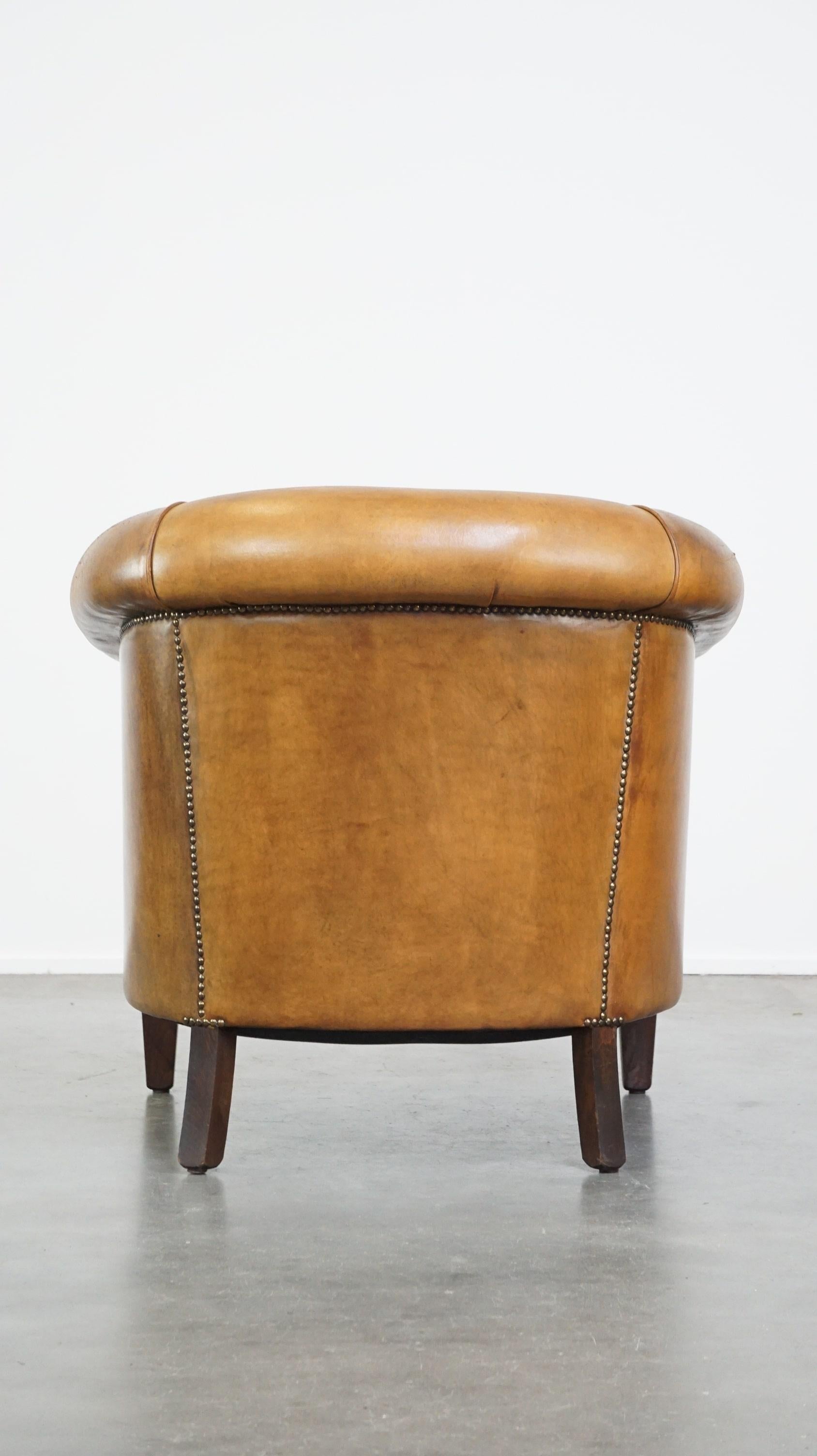Hand-Crafted Comfortable, warm colored sheepskin club chair finished with decorative nails For Sale