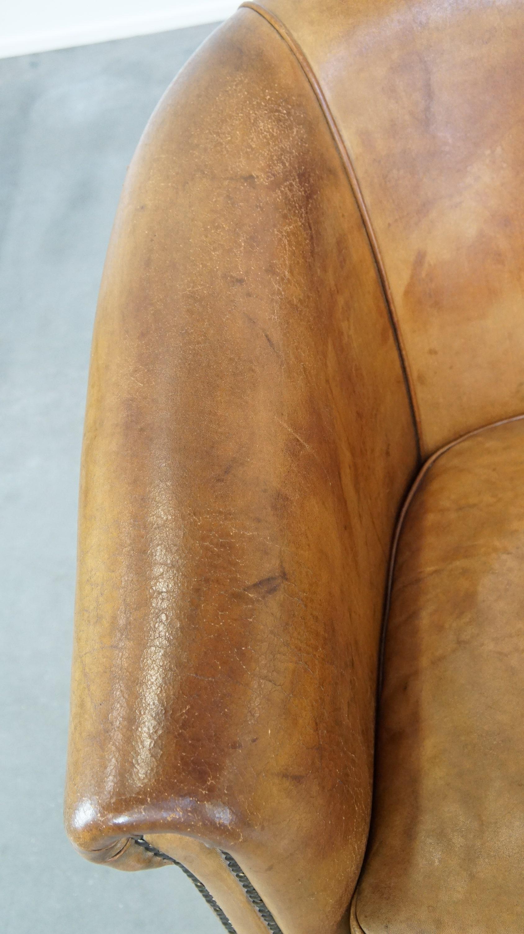 Leather Comfortable, warm colored sheepskin club chair finished with decorative nails For Sale