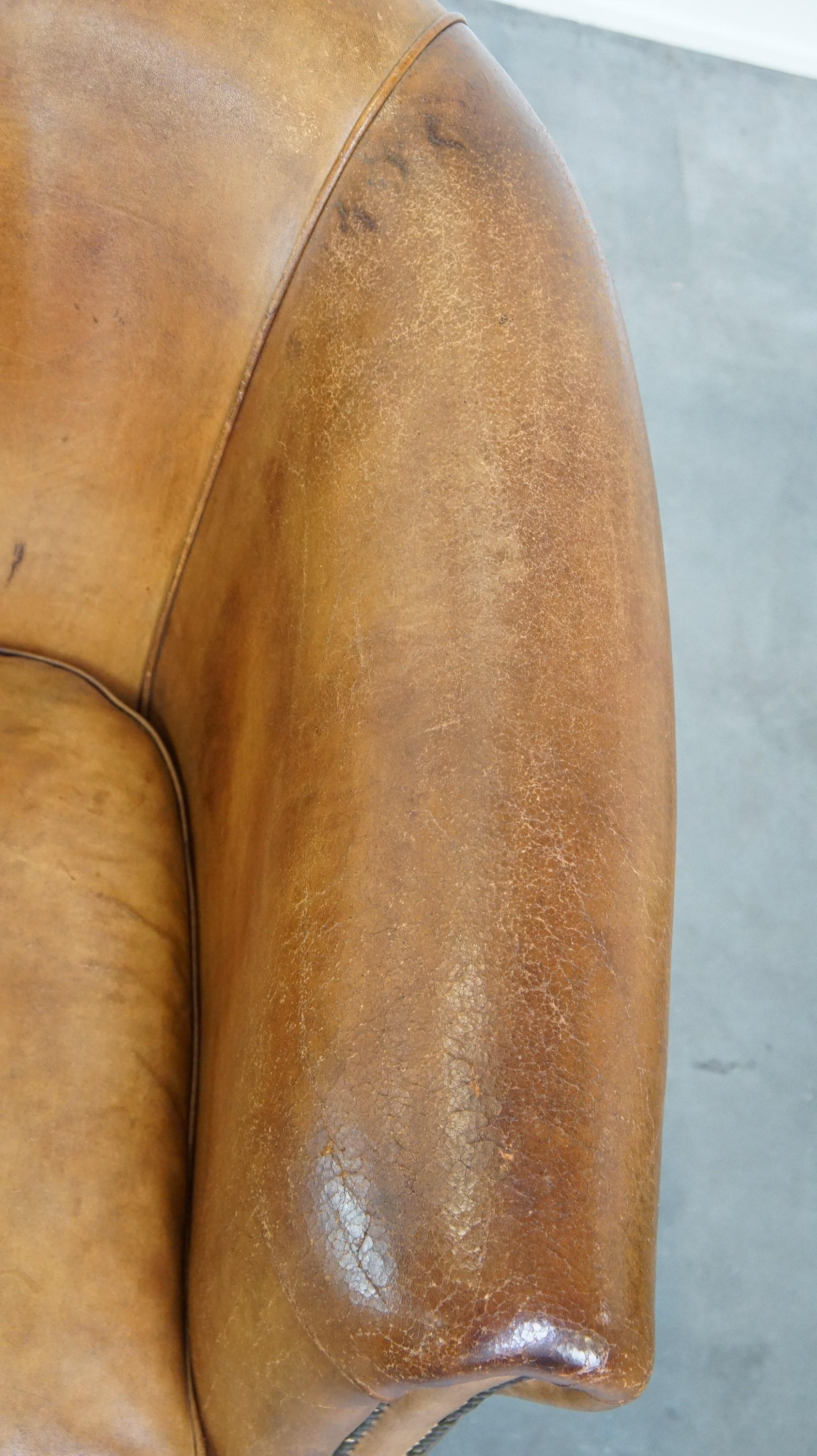 Comfortable, warm colored sheepskin club chair finished with decorative nails For Sale 1