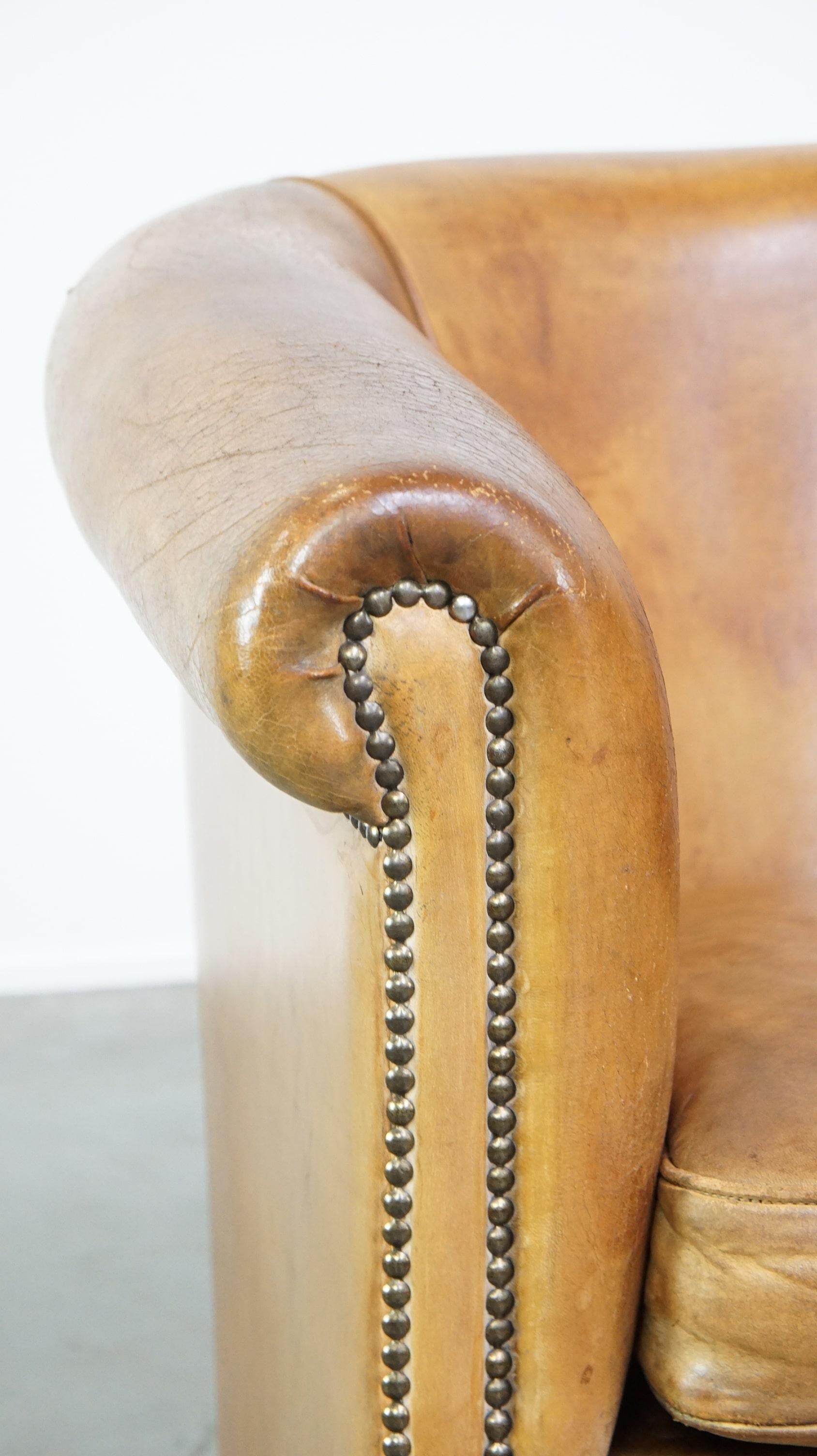 Comfortable, warm colored sheepskin club chair finished with decorative nails For Sale 2