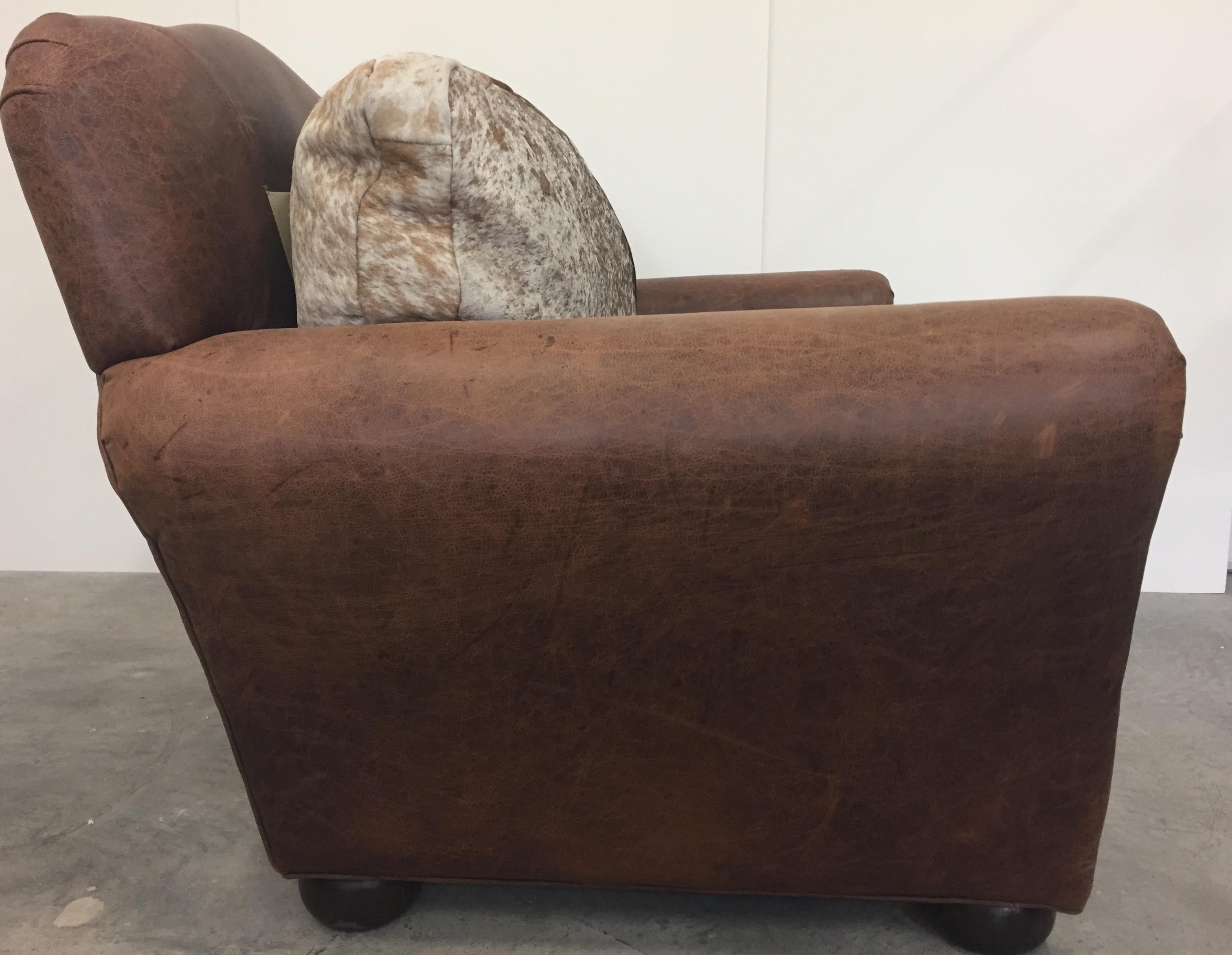 Masculine natural leather and cowhide club chair with nailhead details, roomy and super comfy.

Seat height 20 inches.
