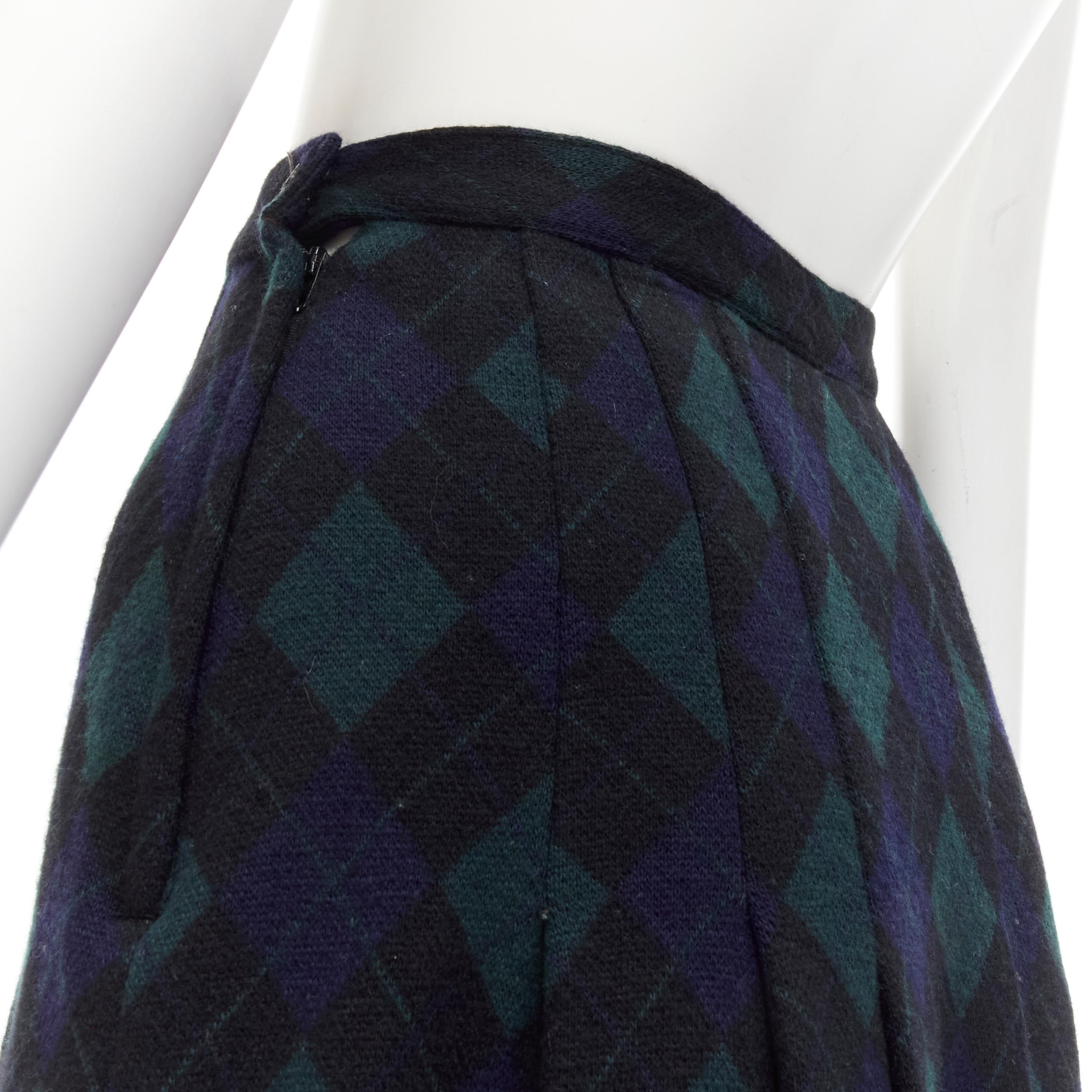 COMME DES GARCONS 1970s Vintage navy green plaid check pleated midi skirt S 
Reference: CRTI/A00650 
Brand: Comme Des Garcons 
Designer: Rei Kawakubo 
Material: Wool 
Color: Green 
Pattern: Check 
Closure: Zip 
Extra Detail: Pleated skirt. Button