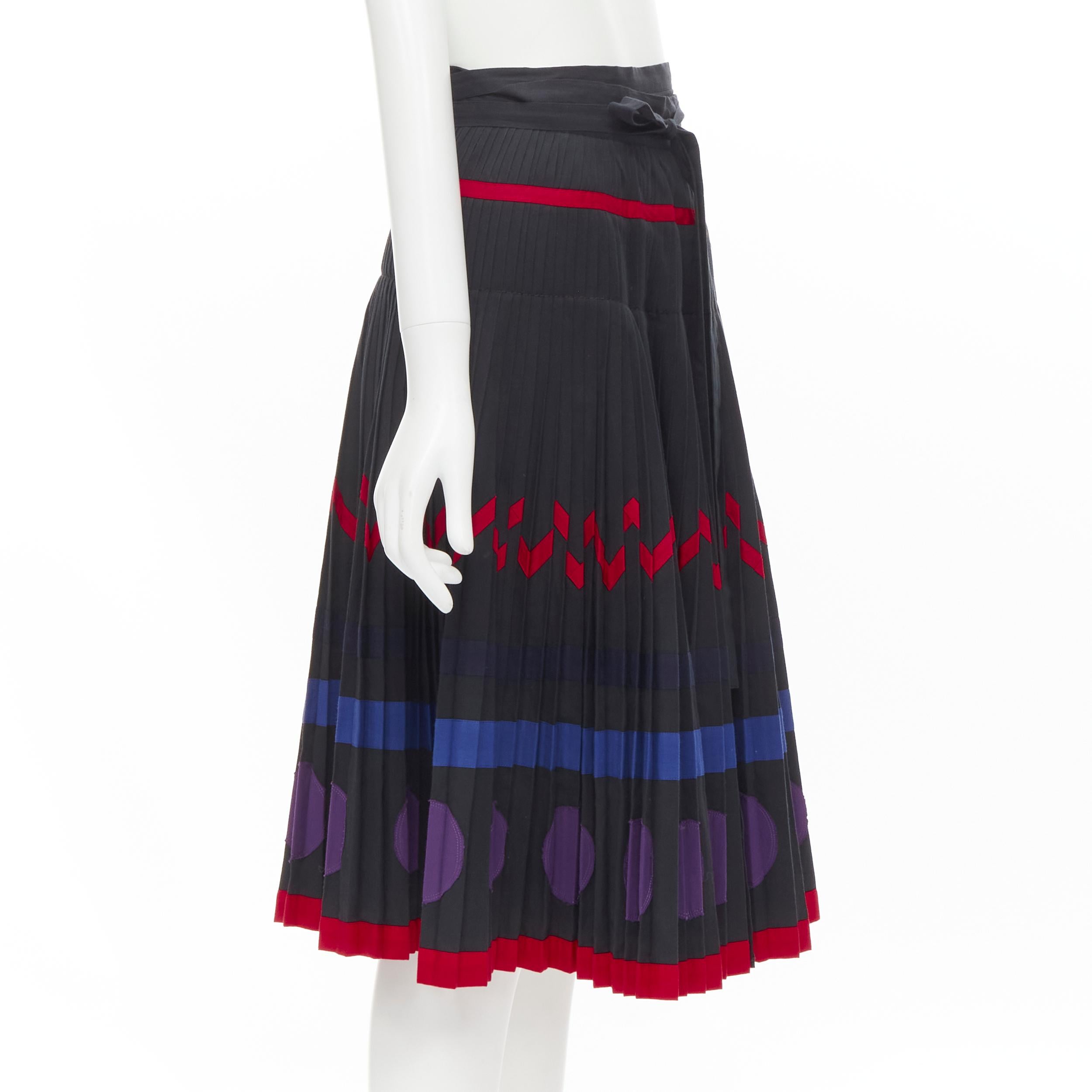 COMME DES GARCONS 1980s black geometric pattern pleated wrapped flared skirt S 
Reference: CRTI/A00510 
Brand: Comme Des Garcons 
Designer: Rei Kawakubo 
Material: Cotton 
Color: Black 
Pattern: Solid 
Extra Detail: Wrap skirt with self tie belt.