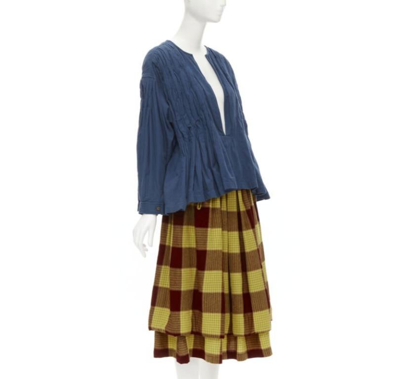 COMME DES GARCONS 1980's Vintage blue shirred stitch top layered checked skirt M
Reference: CRTI/A00689
Brand: Comme Des Garcons
Designer: Rei Kawakubo
Material: Cotton, Wool
Color: Blue, Yellow
Pattern: Checkered
Closure: Zip
Extra Details: Top: