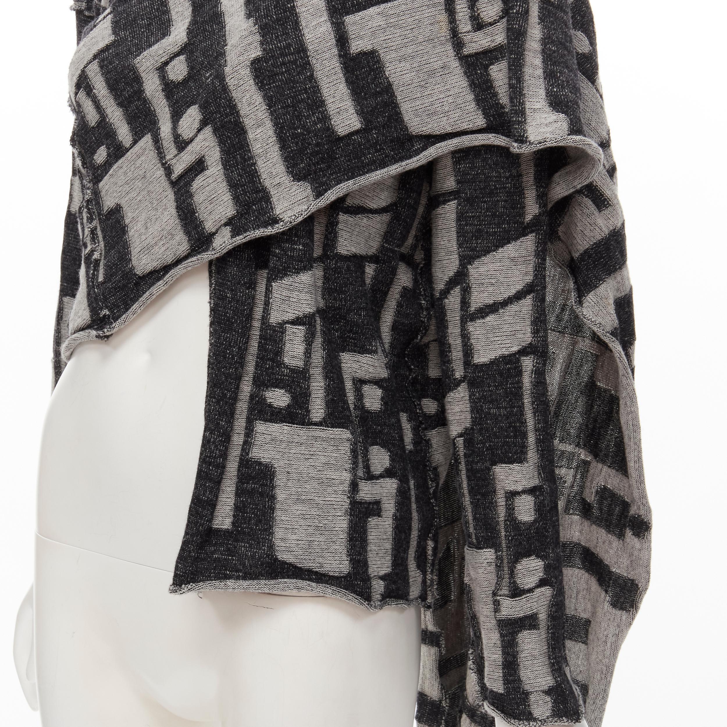 COMME DES GARCONS 1980's Vintage grey abstract wool intarsia wrap scarf cardigan 
Reference: CRTI/A00672 
Brand: Comme Des Garcons 
Designer: Rei Kawakubo 
Collection: 1980s 
Material: Wool 
Color: Grey 
Pattern: Check 
Extra Detail: Attached wrap