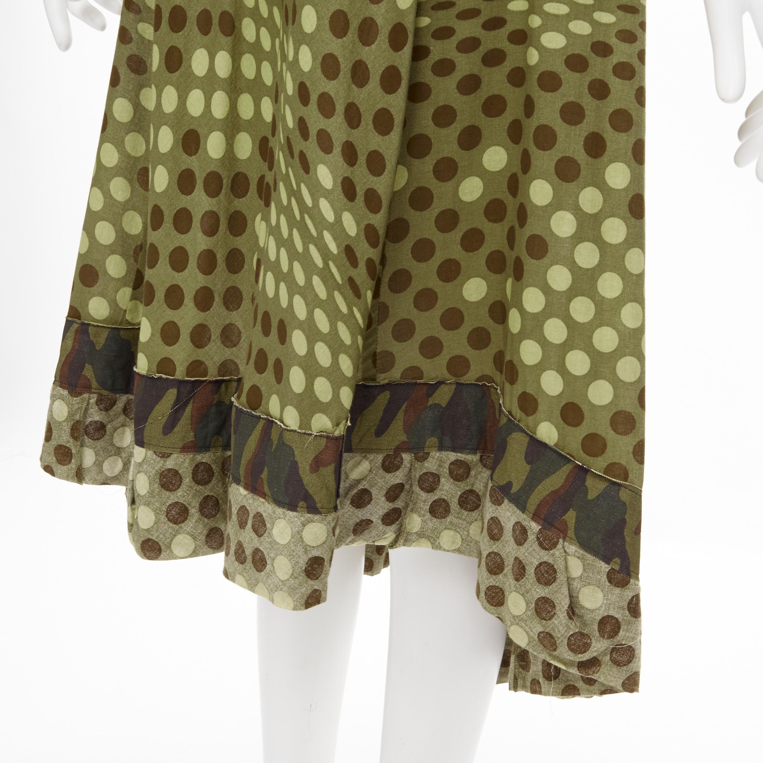 COMME DES GARCONS 2000 green polka dot cotton camouflage hem midi dress M 
Reference: CRTI/A00406 
Brand: Comme Des Garcons 
Collection: 2000 
Material: Cotton 
Color: Green 
Pattern: Polka Dot 
Closure: Zip 
Extra Detail: Shirred bdice. Raw drated