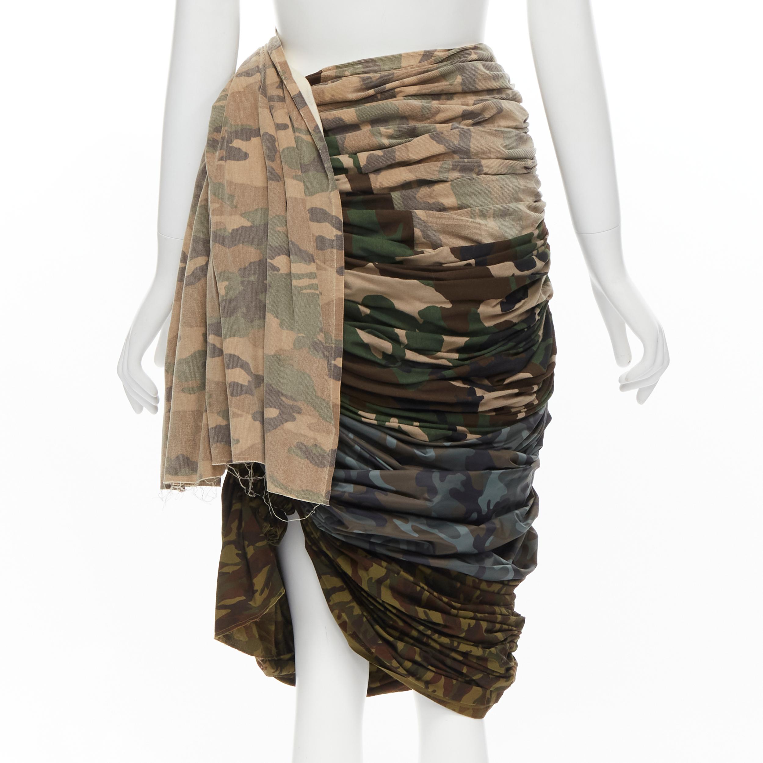 COMME DES GARCONS 2005 Runway mixed blue green camo ruched draped skirt XS 
Reference: CRTI/A00587 
Brand: Comme Des Garcons 
Designer: Rei Kawakubo 
Collection: 2005 Runway 
Material: Cotton 
Color: Green 
Pattern: Camouflage 
Closure: Zip 
Extra