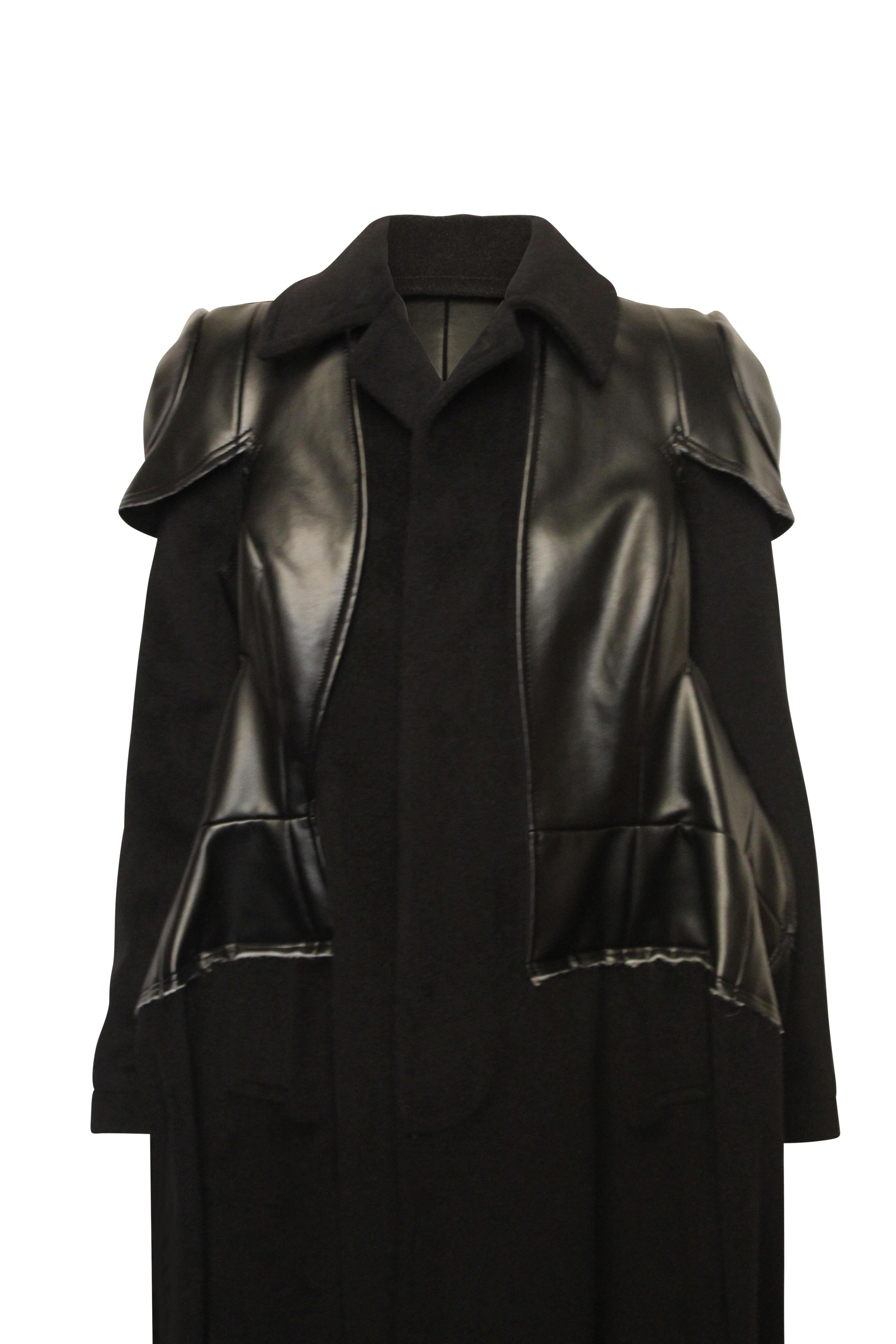 Comme des Garçons 2017 black sculptural coat made from incredibly soft angora and wool. Faux leather detail creates a sharp structure accentuating the shoulders and upper body and a beautiful peplum shape is created at the hips.
Made in Japan.
Size