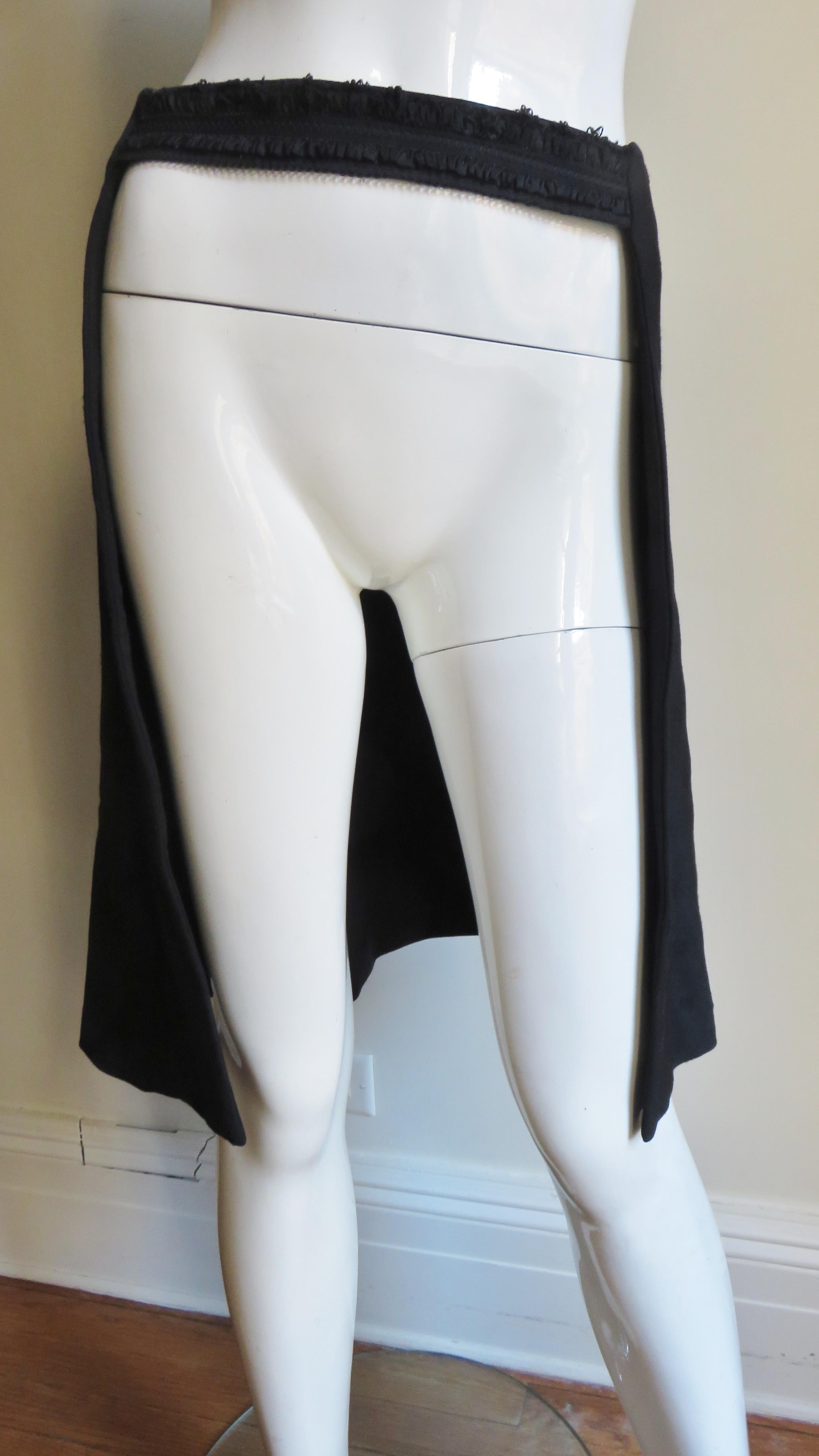 A great black overskirt from Comme des Garcons, CDG.  It consists of an open front skirt with a stretch waistband.
Fits sizes Small, Medium. Marked Japanese size S.

Waist  30-33