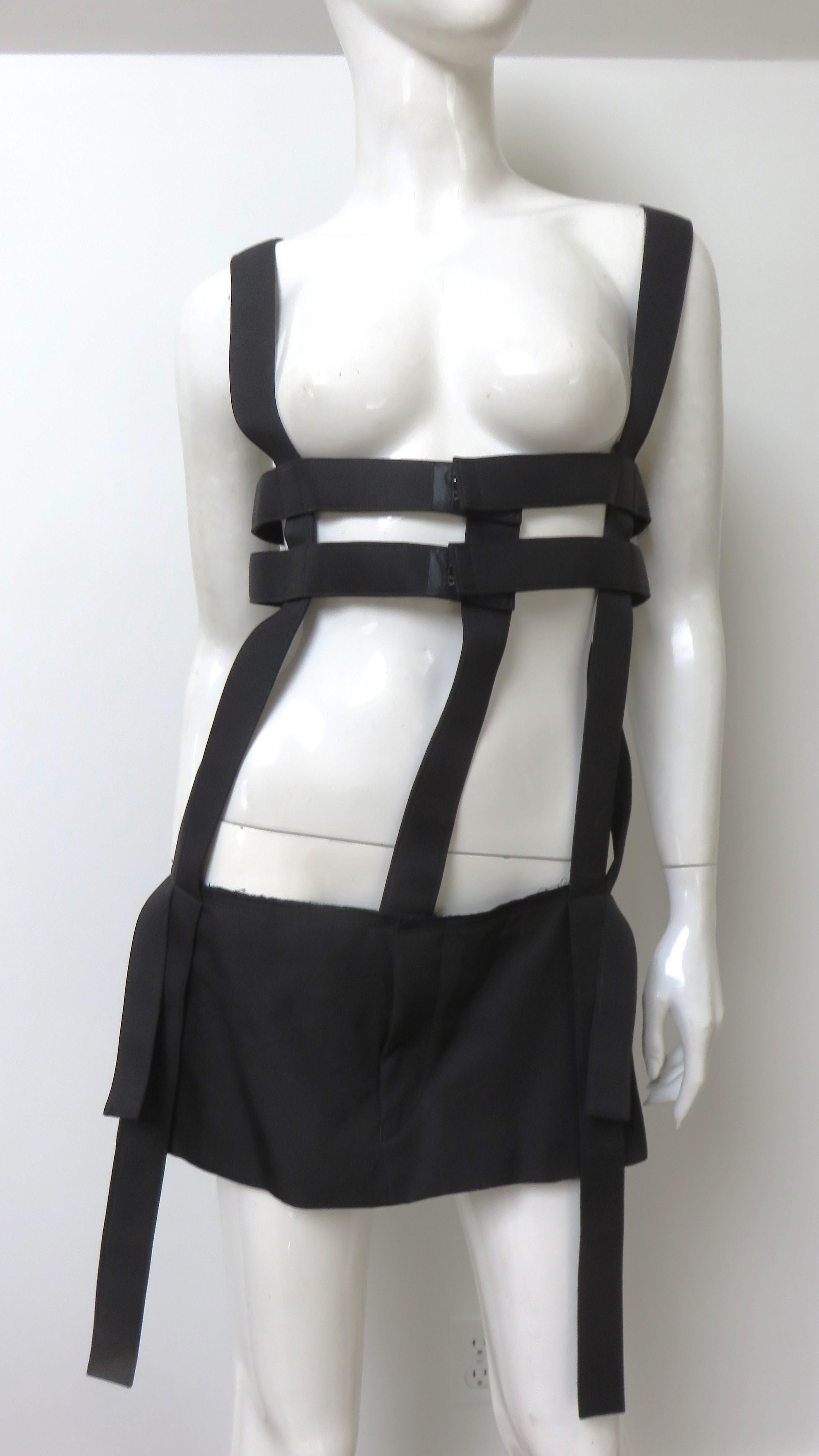 A fabulous black vest from Comme des Garcons. It is comprised of vertical and horizontal bands which attach to a small 8