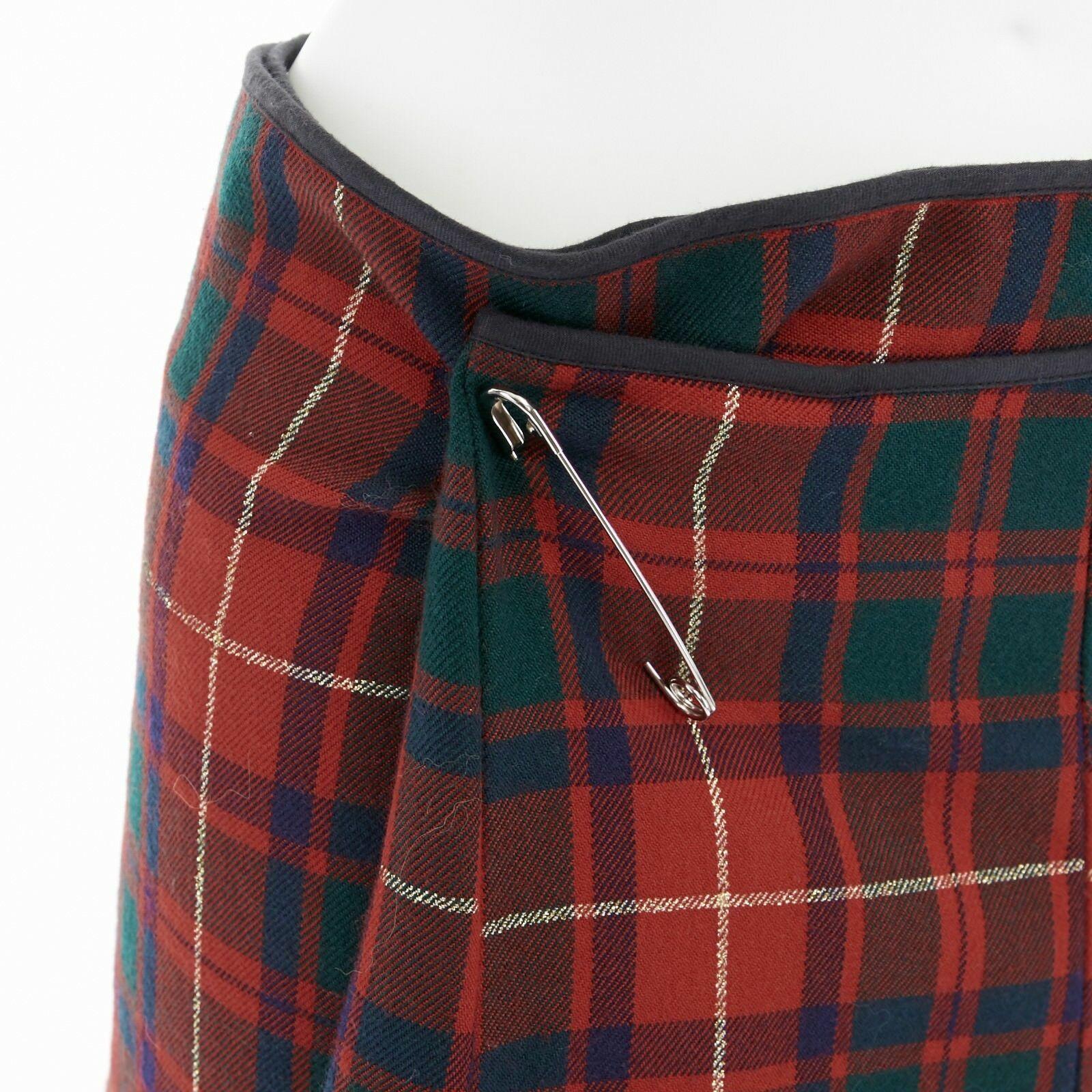 COMME DES GARCONS AW99 punk red tartan plaid ruffle hem layered wrap pin skirt M
COMME DES GARCONS
FROM THE FALL WINTER 1999 COLLECTION
100% wool. Red, green, navy punk-inspired plaid tartan wool. 
Dual layered. Self wrap around skirt. 
Does not