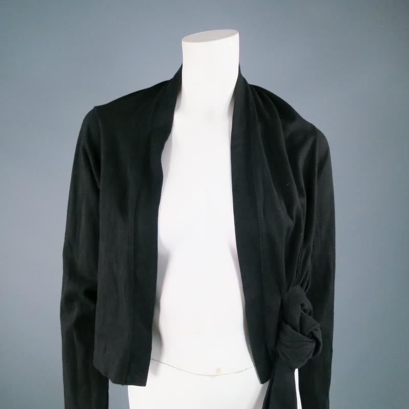 Fabulous black cotton bolero cardigan by COMME DES GARCONS. A cropped, long sleeve piece that is tied and knotted into an avant garde backless layering piece. A great way to add some texture to an outfit that feels dull. Made in Japan.

Excellent