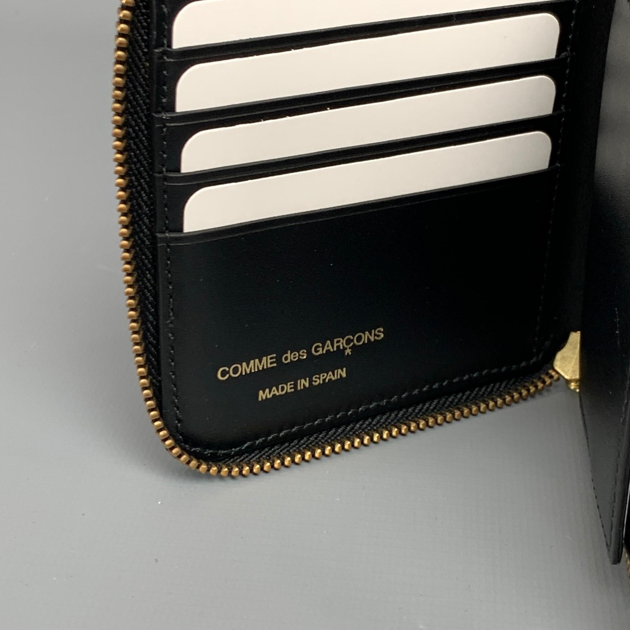 COMME des GARCONS wallet comes in a black embossed leather featuring card slots, coin pocket, and a zipper closure. Made in Spain.

New With Box. 

Measurements:

Length: 3.5 in.
Width: 0.5 in. 
Height: 4.5 in. 