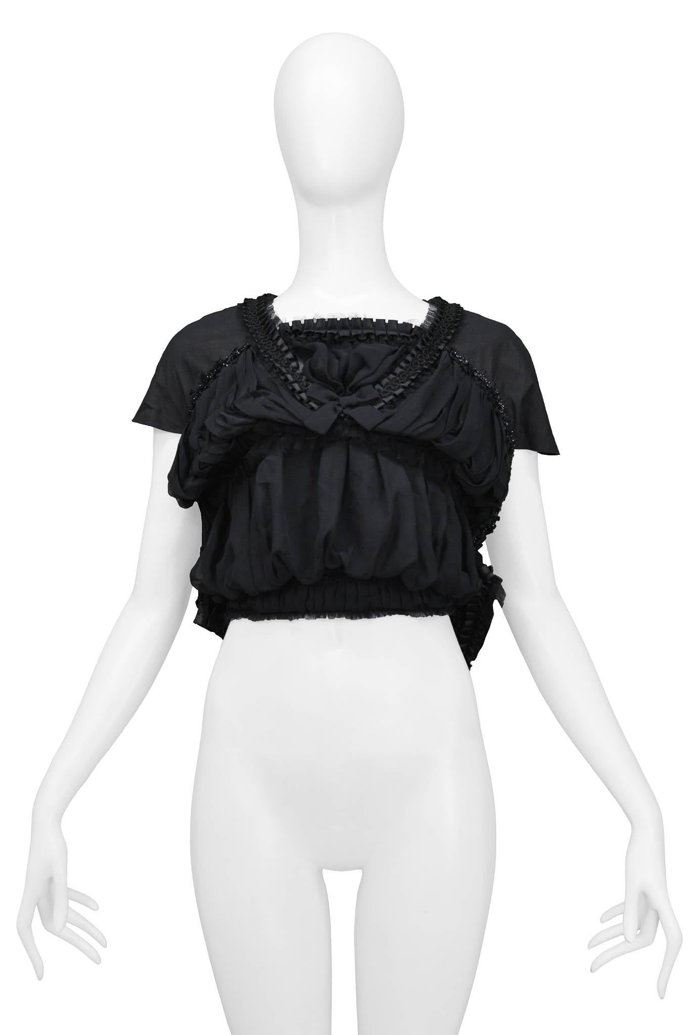 Vintage Comme des Garcons black short sleeve top featuring two rows of shirring creating a double blouson effect and pleated satin ribbon at neckline. Circa 2006.