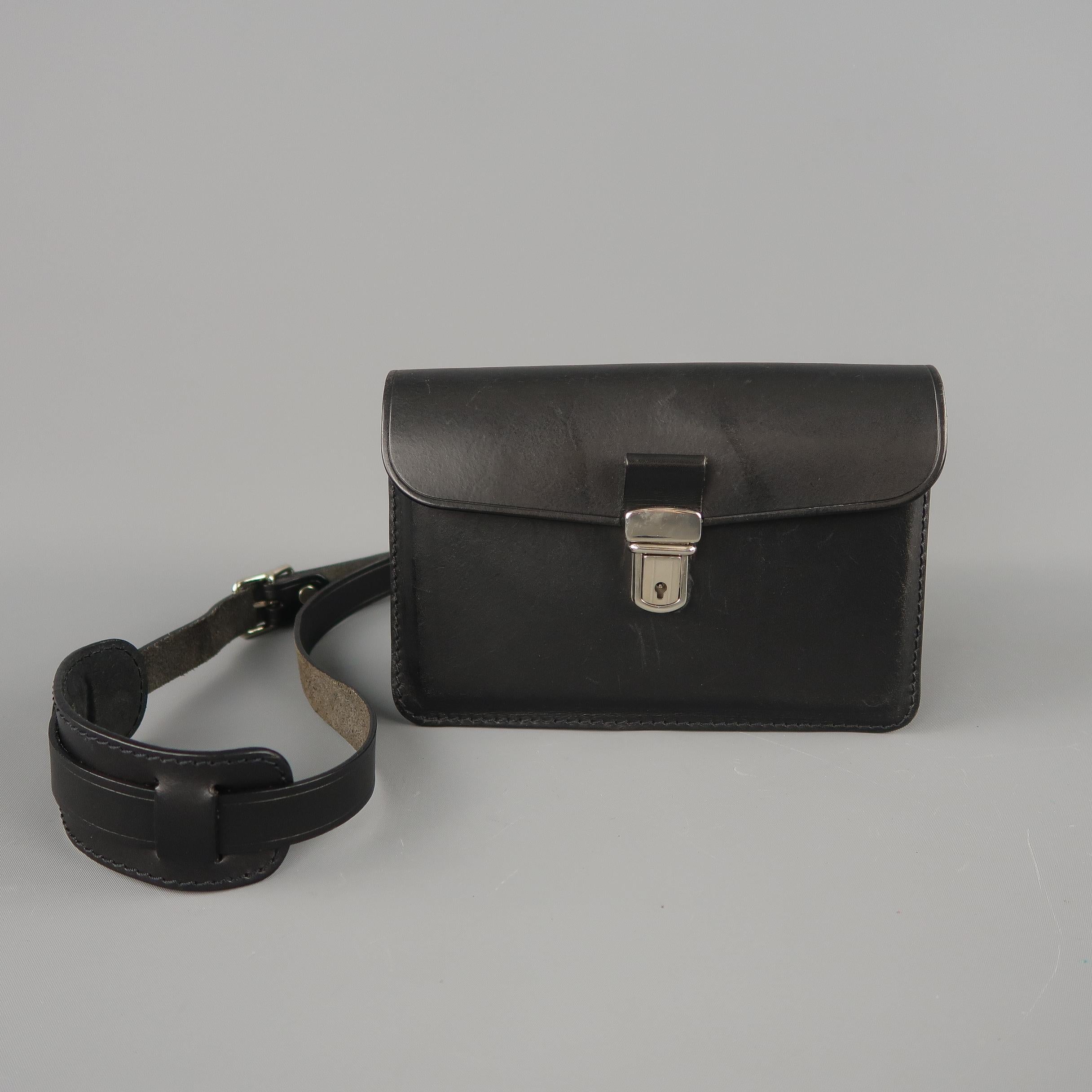 COMME des GARCONS mini satchel comes in structured black leather with a silver tone button snap flap closure, zip top, and detachable strap.
 
Excellent Pre-Owned Condition.
 
Measurements:
 
Length: 8 in.
Width: 2.5 in.
Height: 5.5 in.
Drop: 26 in.