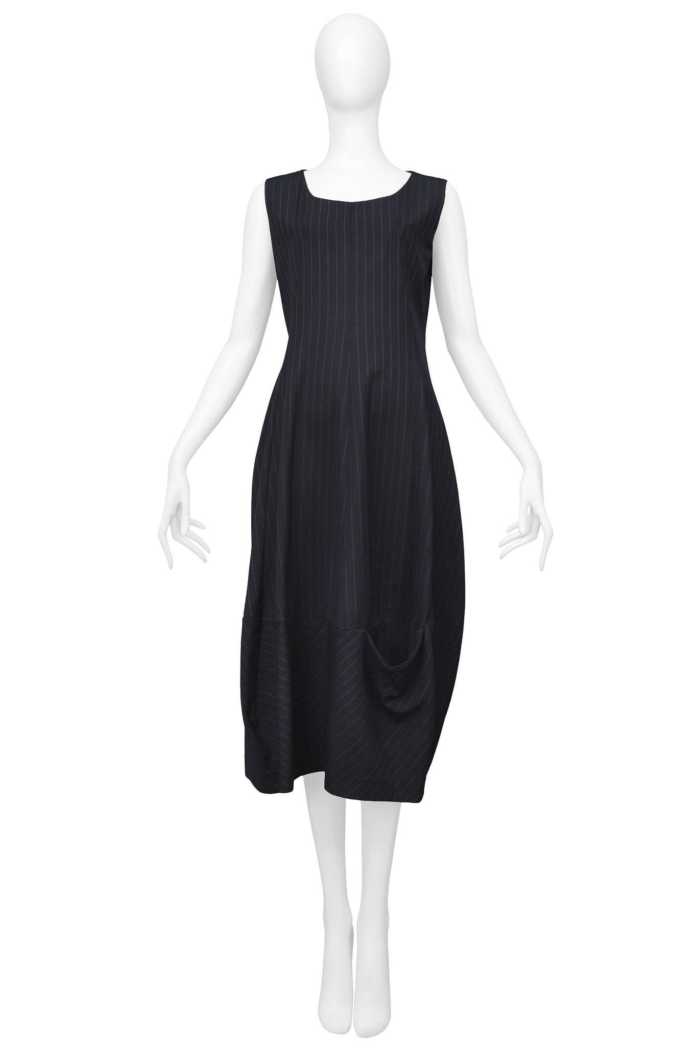 Resurrection Vintage is excited to offer a vintage Comme des Garcons black pinstripe dress featuring pockets on the front and back bottom hem, back zipper, and asymmetrical shaping along the skirt hem.

Comme Des Garcons
Size: Small
Fabric: 100%