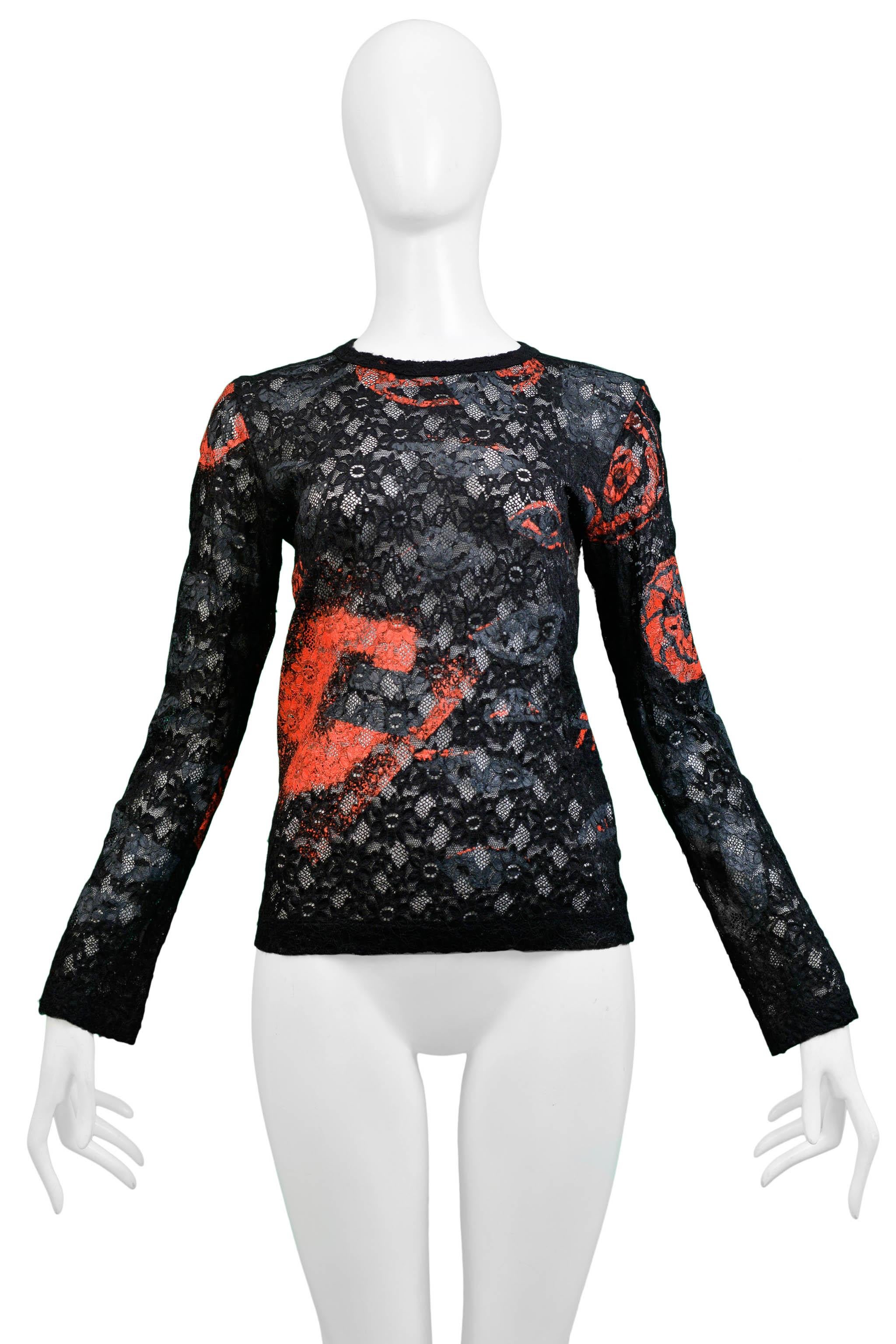 Resurrection Vintage is excited to offer a vintage Comme des Garcons black stretch lace top featuring a high collar, long sleeves, and red, black, and grey screenprint on lace. 

Comme Des Garcons
Size Small
2000 Collection
Stretch Lace
Excellent