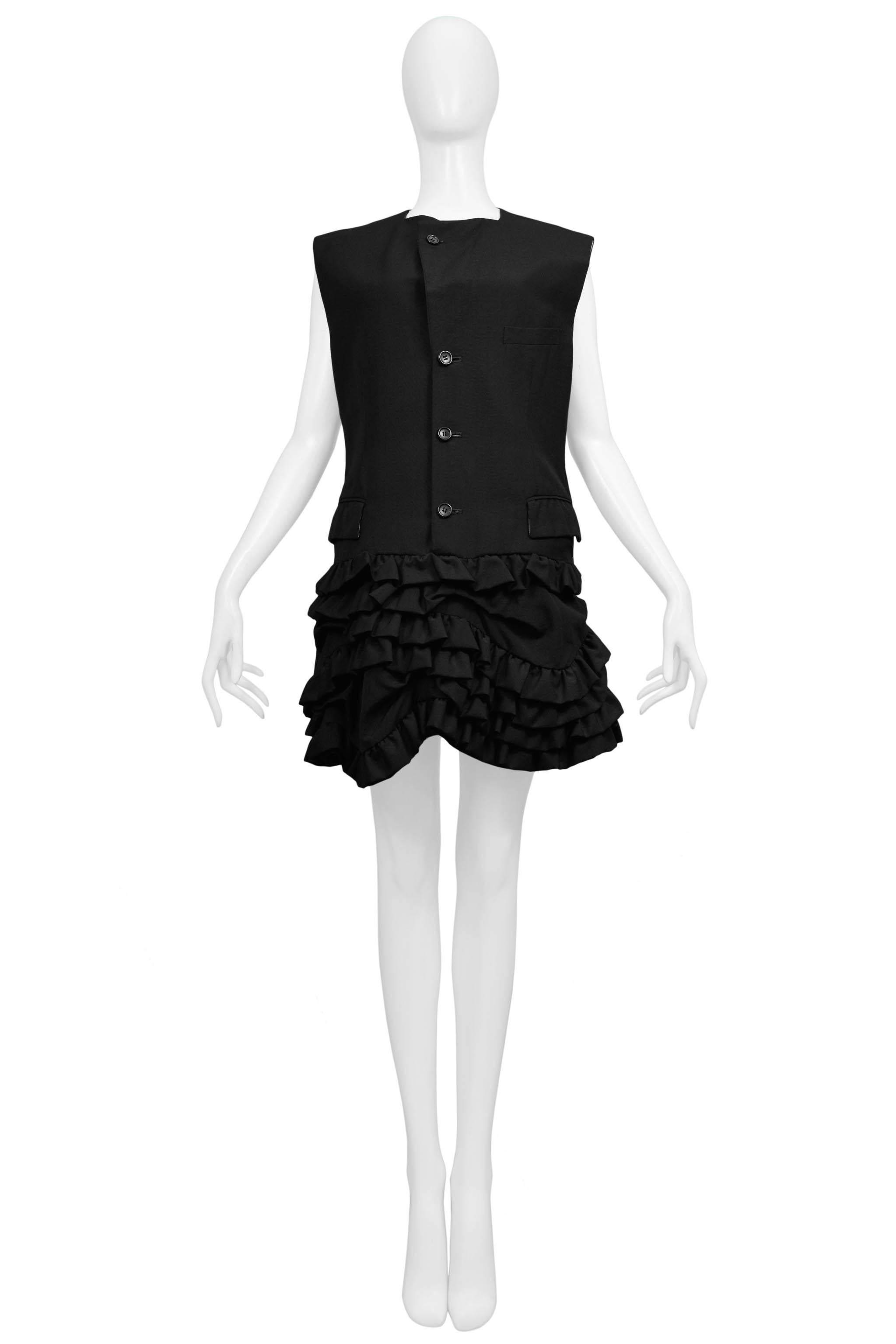 Resurrection Vintage is excited to offer a vintage Comme des Garcons black wool vest dress featuring a button front, strong shoulders, and ruffle skirt. 

Comme Des Garcons
Size Small
1994 Collection
Wool
Excellent Vintage Condition  