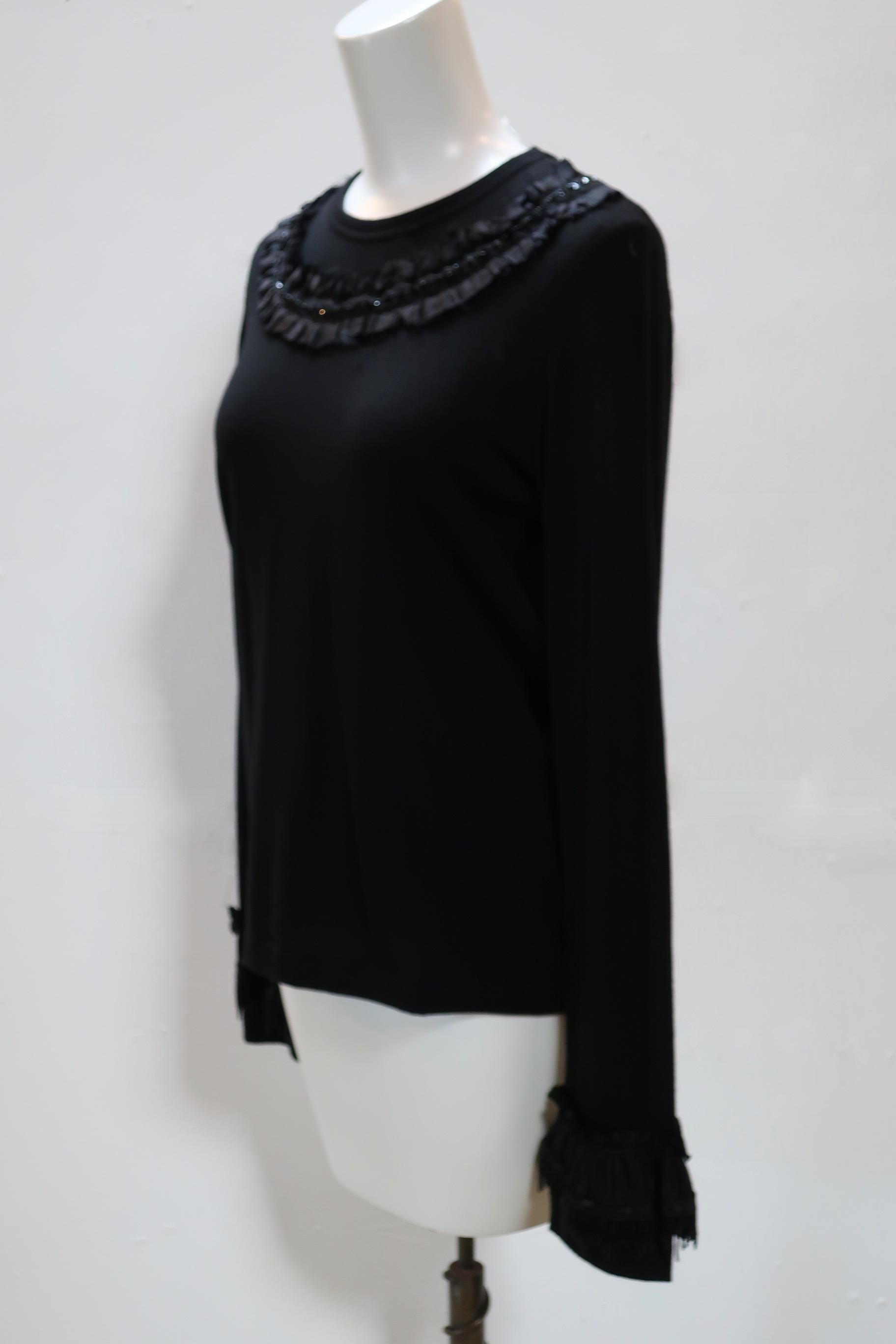 Comme des Garçons black wool knit top with long flared ruffle and sequin embellished sleeves and sequin detailing around collar. Fitted silhouette circa 2007. New with Tags.