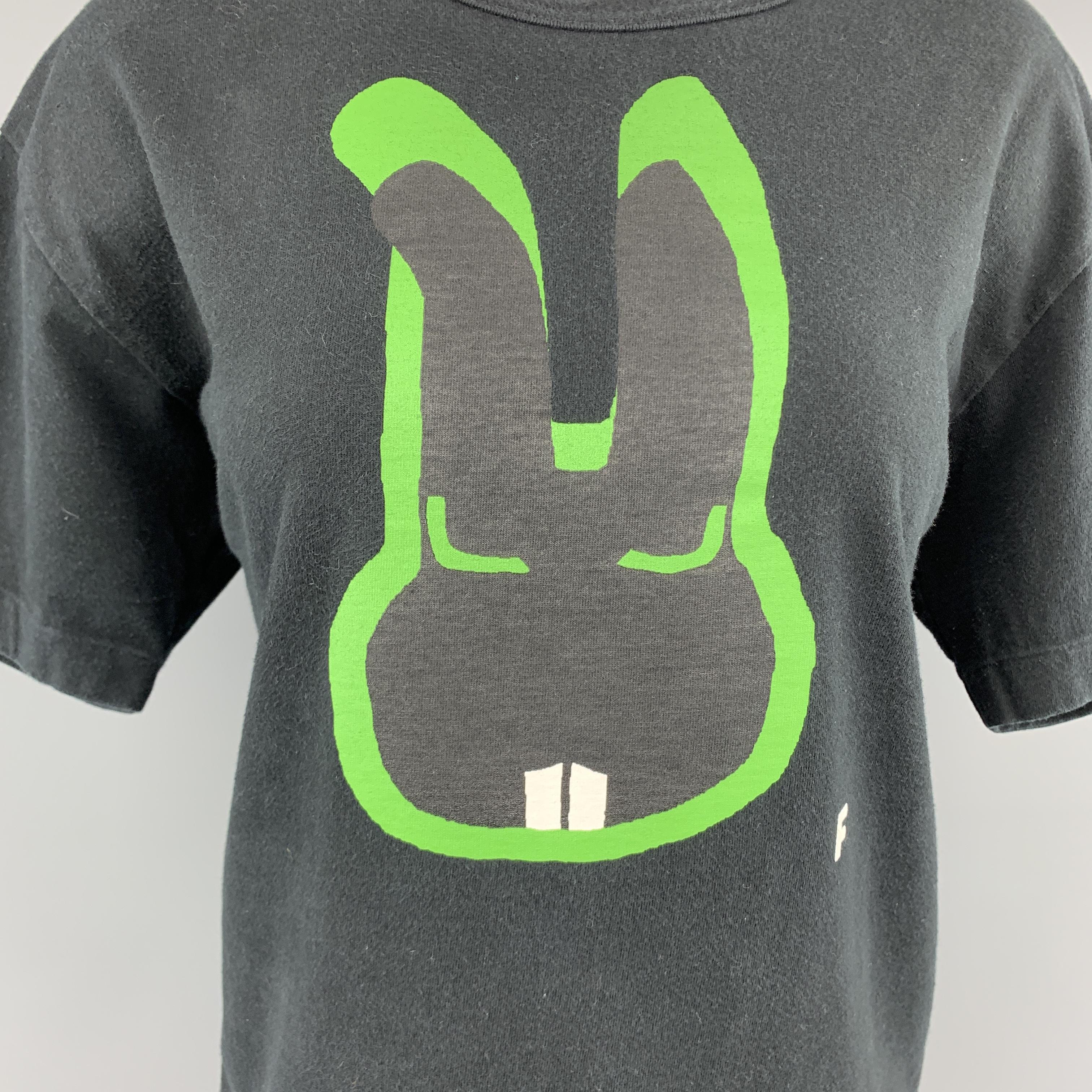 COMME des GARCONS BLACK T-shirt comes in black jersey with a crew neck, short sleeves, and green bunny face F graphic. fading throughout. As-is.
 
Good Pre-Owned Condition.
Marked: XL AD 2012
 
Measurements:
 
Shoulder: 19 in.
Bust: 44 in.
Sleeve: 8