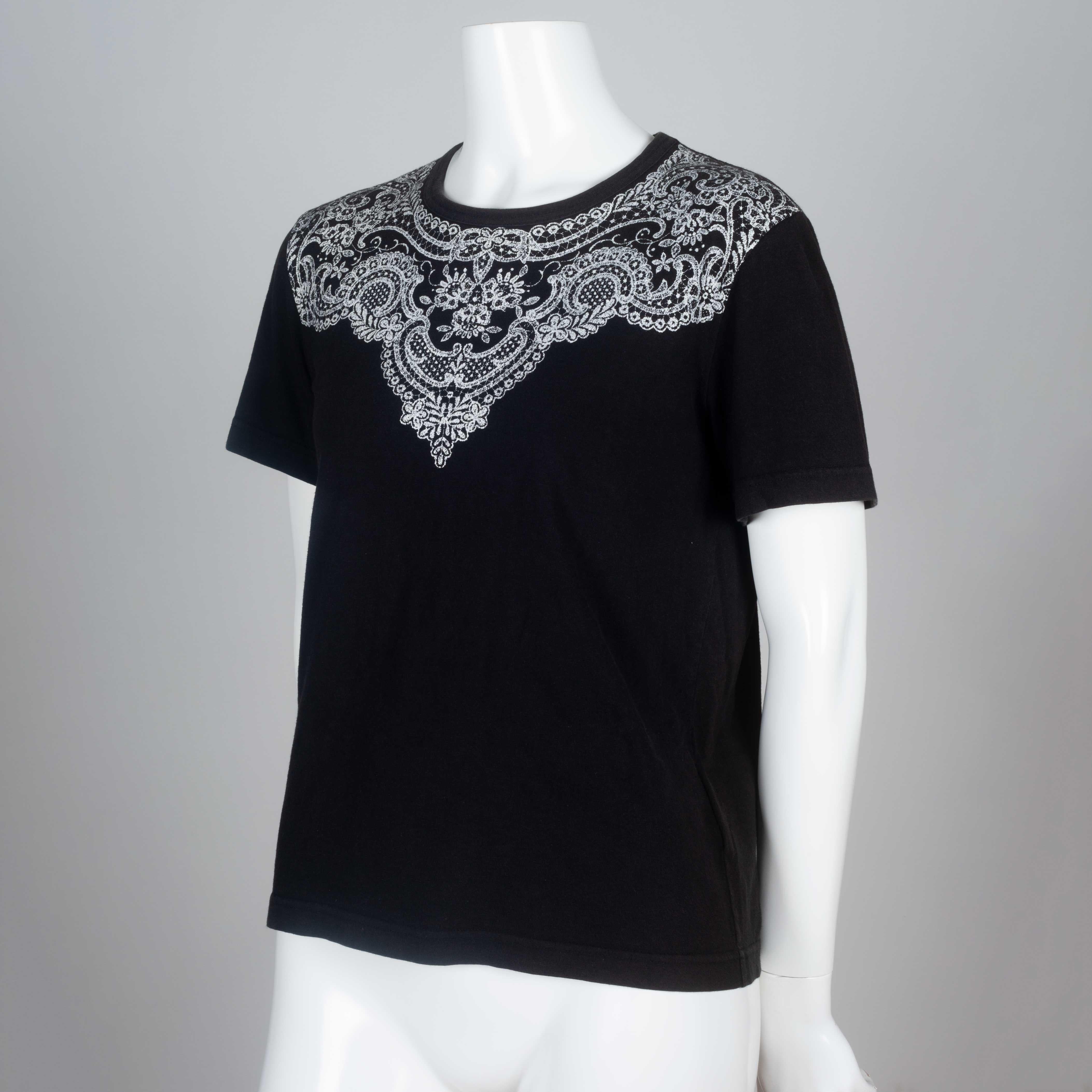 Comme des Garçons 2006 black tee from Japan with lace motif around collar. 

YEAR: 2006
MARKED SIZE: No size marked
US WOMEN'S: S
US MEN'S: XS
FIT: Regular
CHEST: 17