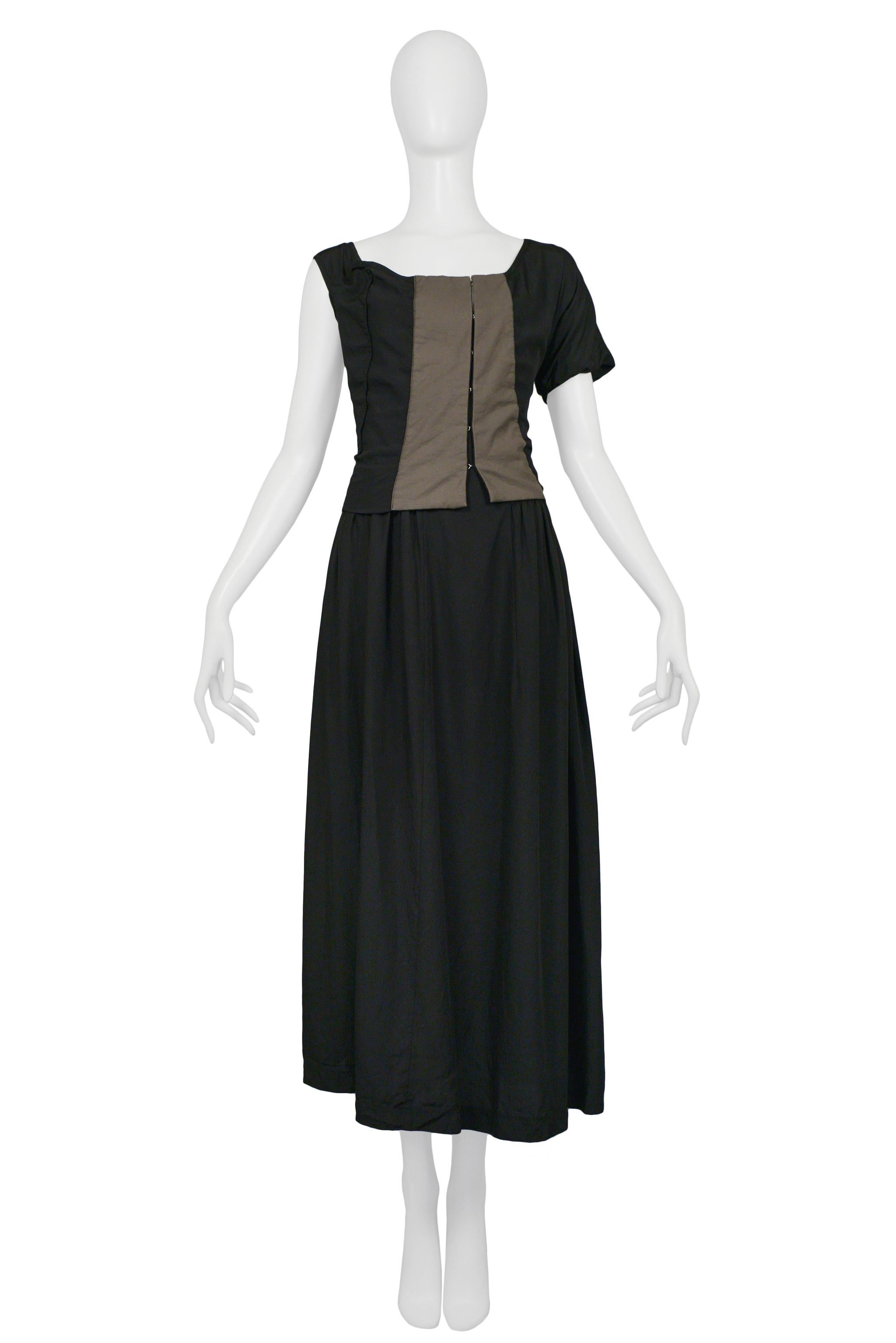 Resurrection Vintage is excited to offer a vintage Comme des Garcons black & taupe rayon panel gown featuring asymmetrical sleeves, boat neckline, contrasting panels, full skirt, and gown length. Circa AW 1997. 

Comme Des Garcons
Size: