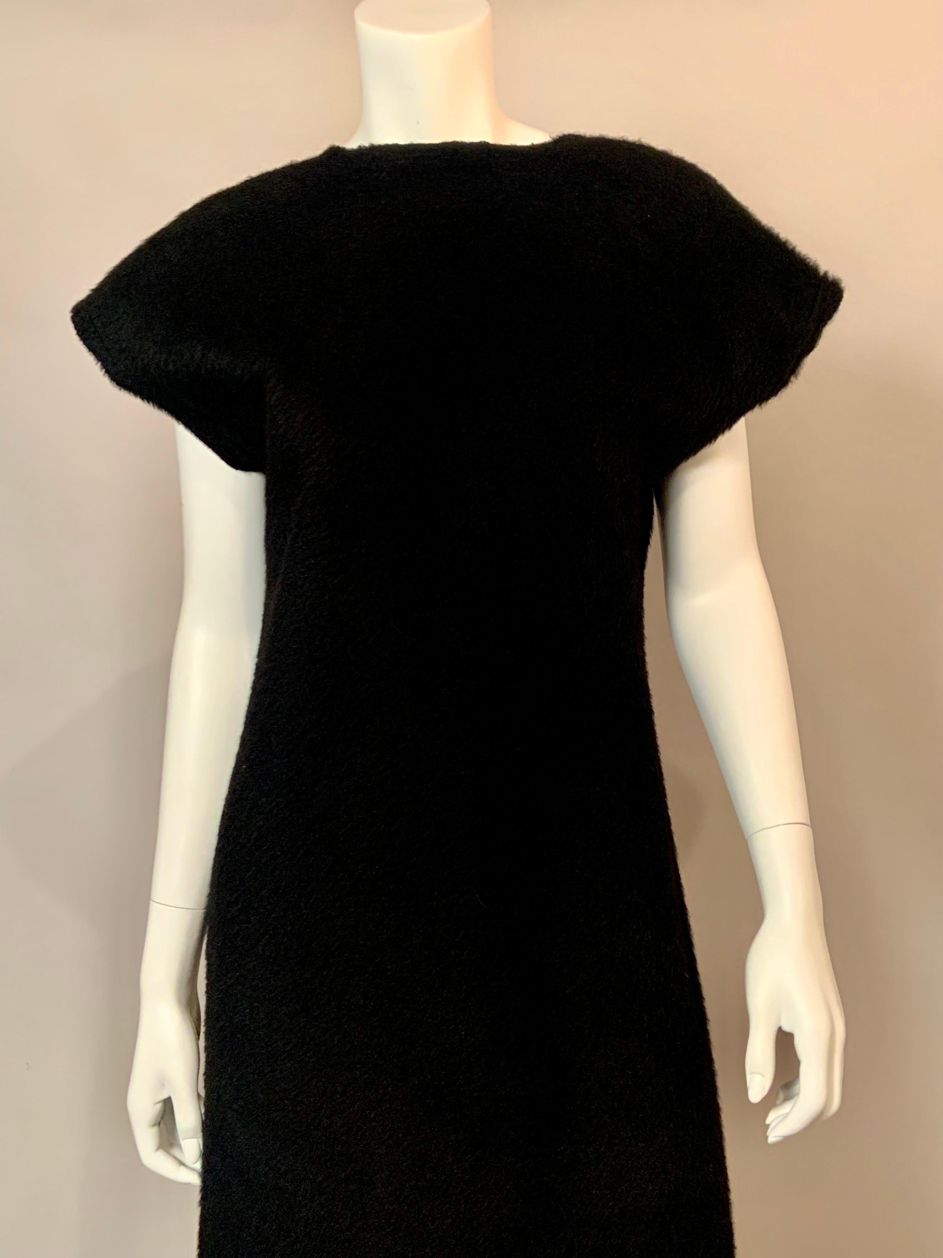 A sleek and modern dress from Comme des Garcons, this piece can be dressed up for evening or accessorized casually for day wear.
The fabric is quite plush,  [no content tag remains],  and adds to the elegance and versatility of the dress.  A simple