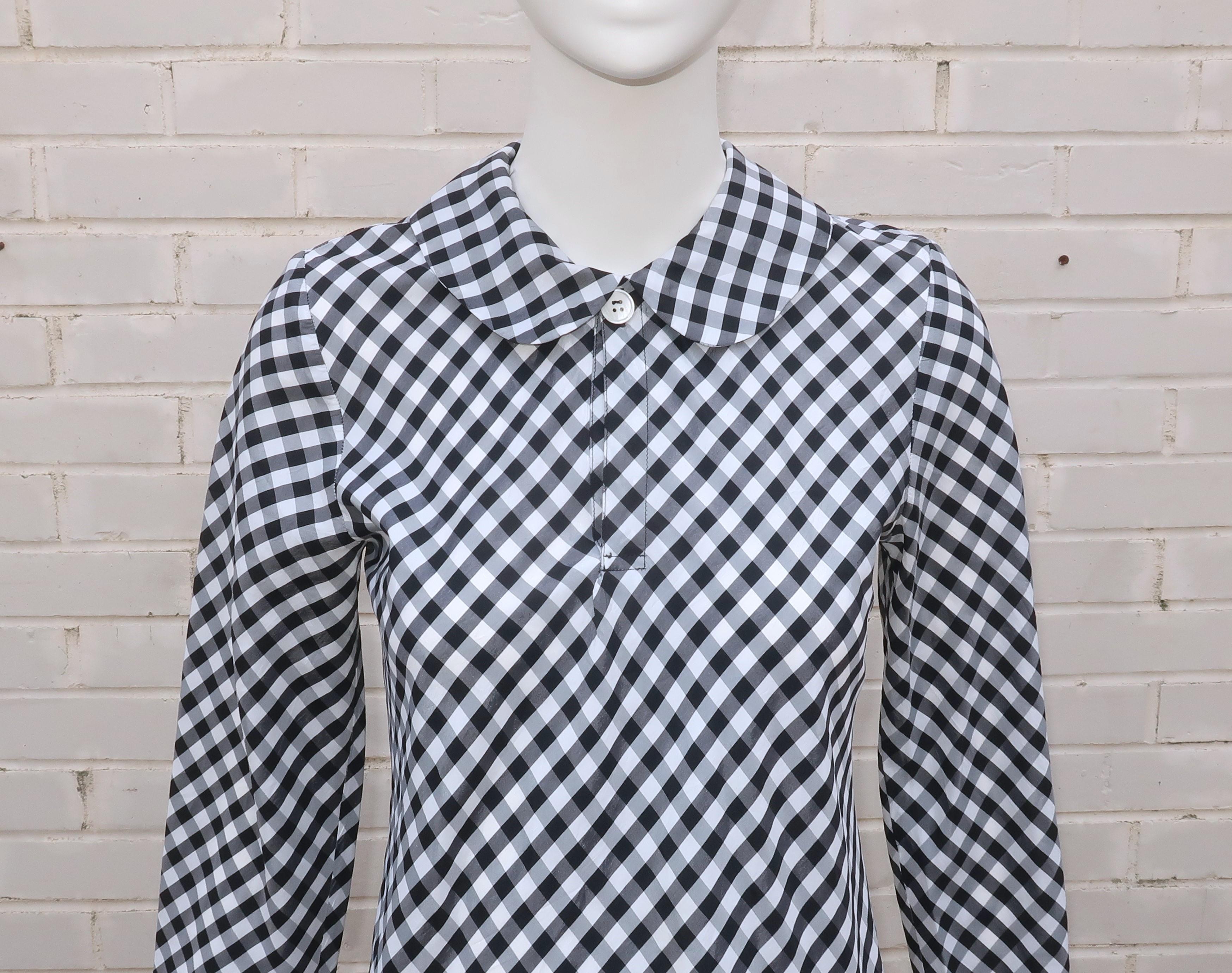 1990’s Comme des Garcons black and white gingham dress with a school girl style Peter Pan collar.  The dress has a pullover construction with a button at the collar.  The fabric is an acetate that has the crisp quality of sateen.  In keeping with
