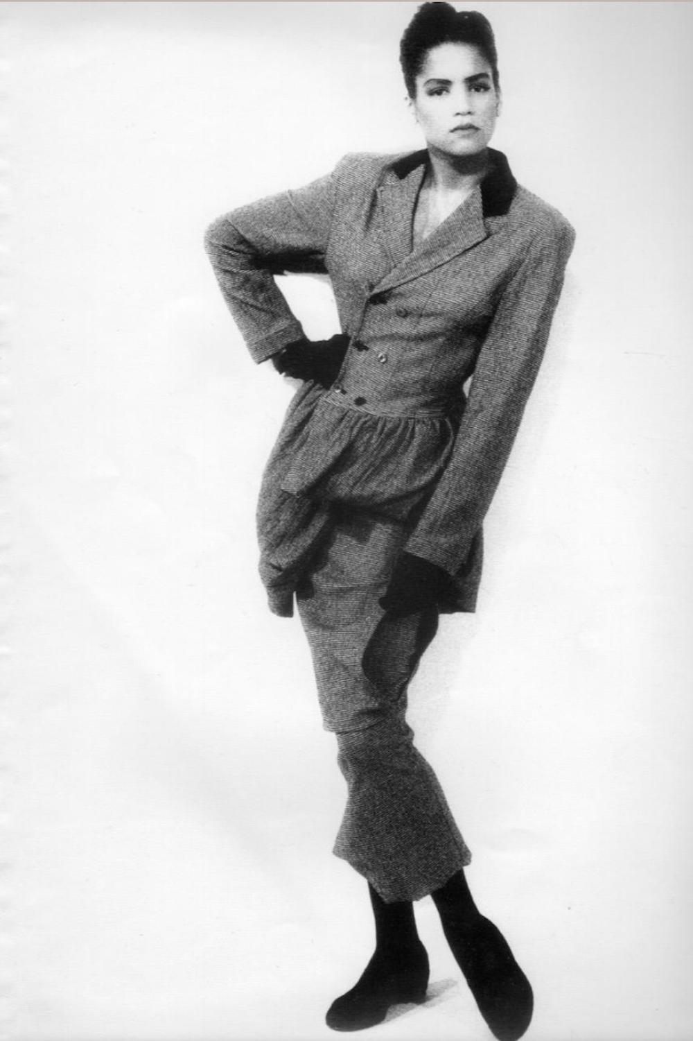 - Autumn / Winter 1986 Comme des Garçons runway collection by Rei Kawakubo

- Sold by Mae Vintage 

- Black avant garde skirt suit. Double breasted jacket with voluminous peplum. Long pencil skirt with asymmetric hem

- Black synthetic material